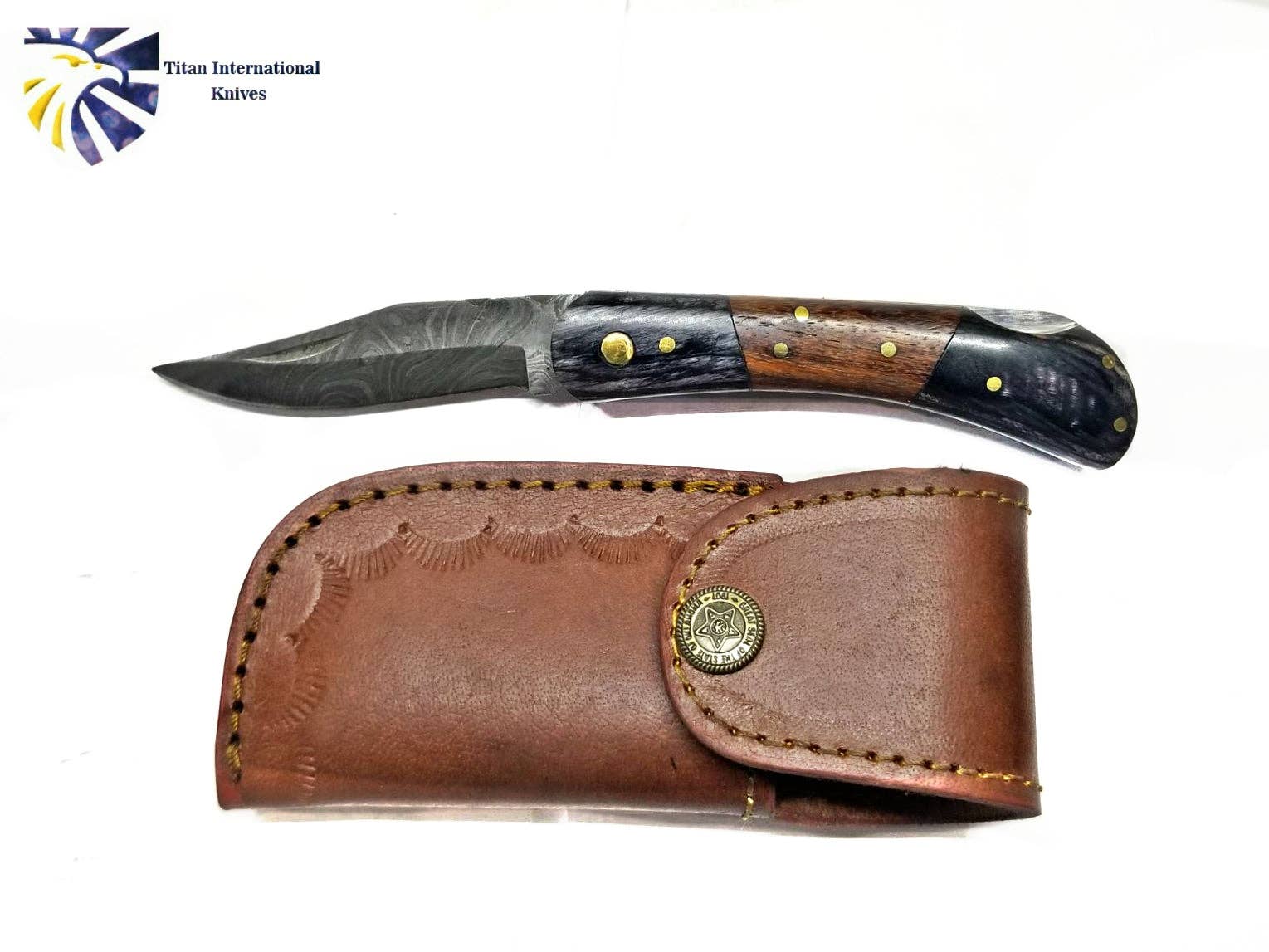 The Knife: Damascus Steel Pocket knife features a decorated Damascus steel blade and walnut wood handle, displayed next to a stitched brown leather sheath with a brass button. The Titan International Knives logo is shown in the corner.