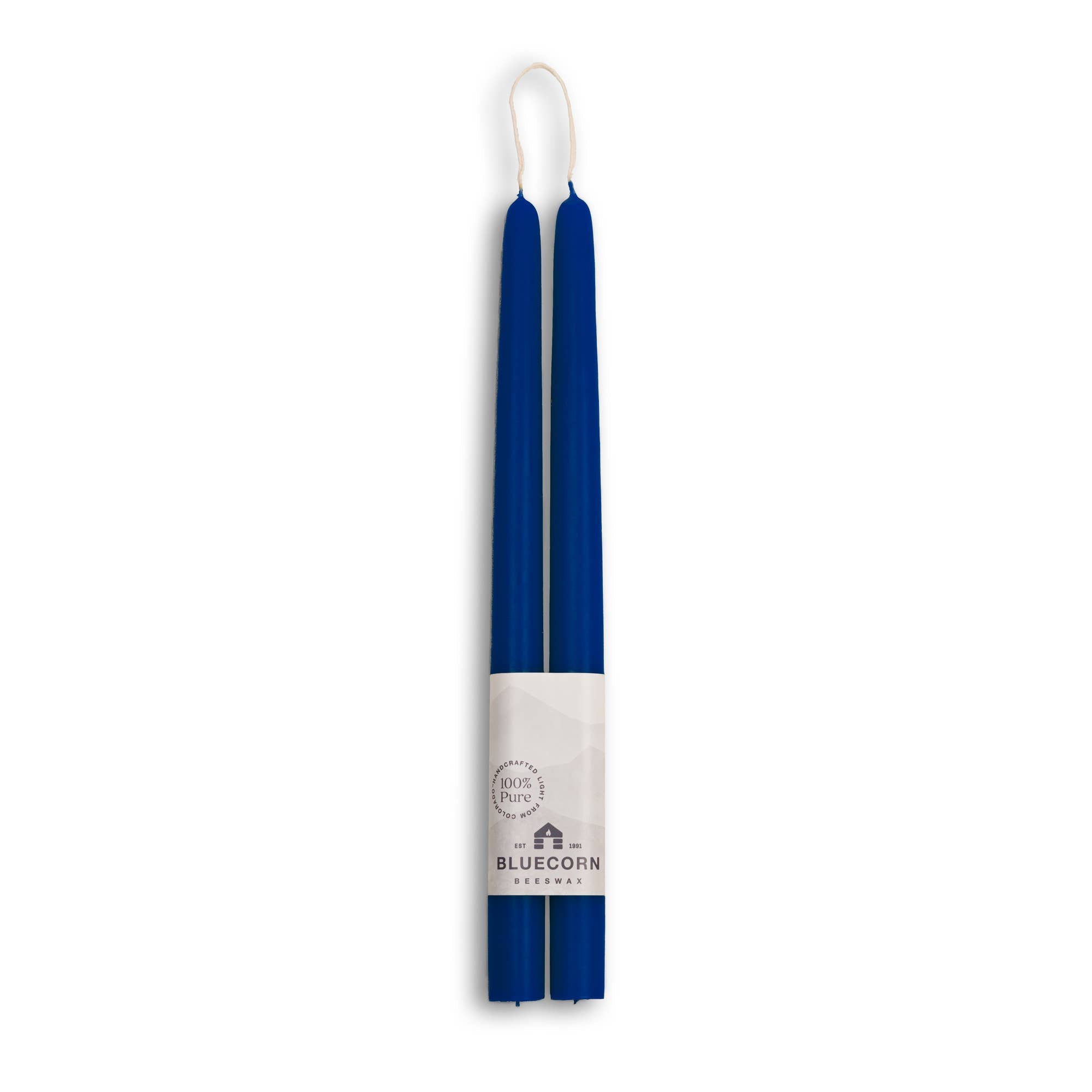 A pack of two 10 eco-friendly beeswax taper candles, dripless and handmade, comes with a white label featuring the Bluecorn logo for clean and elegant lighting.