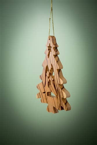 The Ornament: Christmas Tree with Nativity is a 3.5" olive wood Christmas tree ornament from Bethlehem, featuring cut-out star and tree shapes, handcrafted and hanging by a gold string against a green background.