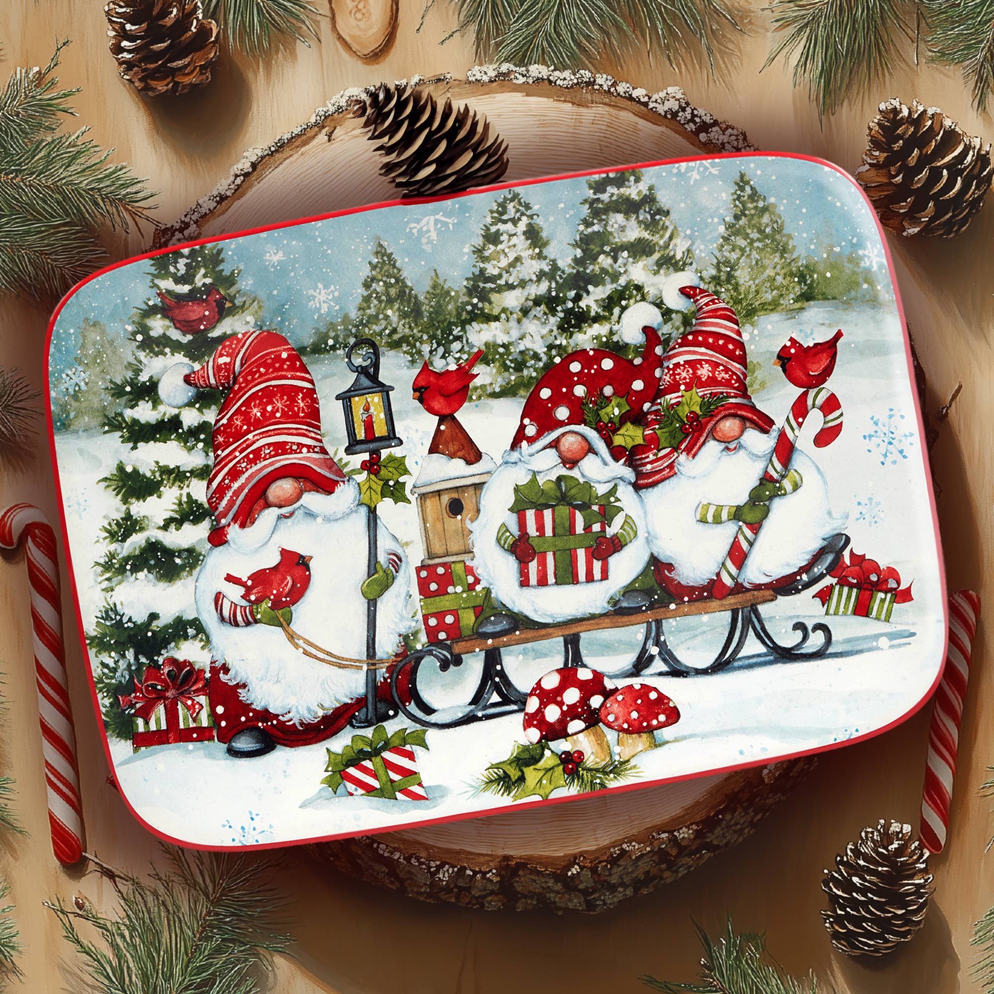 The Tray: Christmas Gnomes Rectangular Platter 14in x 10in showcases three festive gnomes with gifts, cardinals, candy canes, and pine cones in a snowy Nordic scene—ideal holiday serveware.