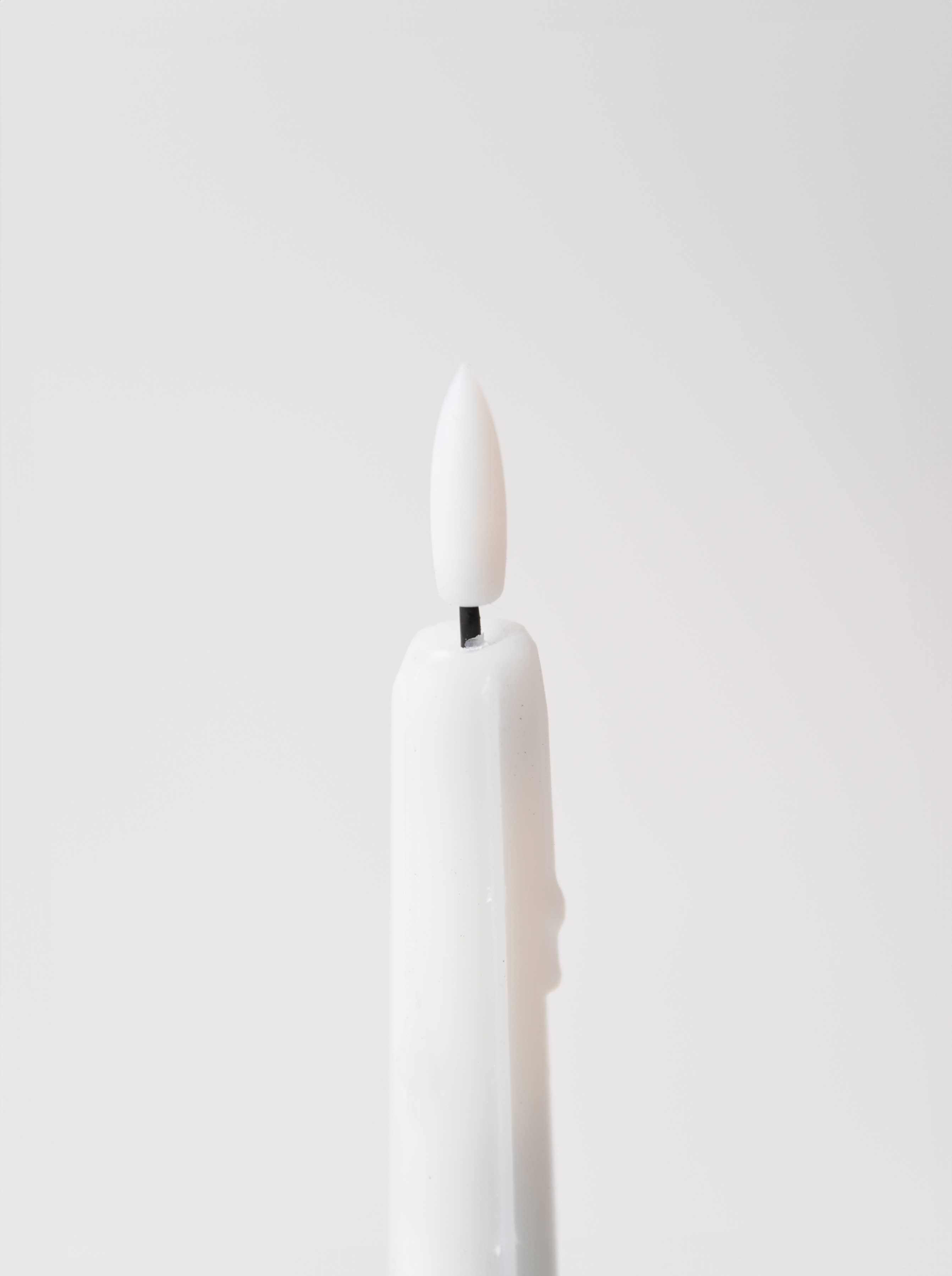 The Candle: Holiday Special Realistic Flame Battery Taper: Plain features a white, battery-operated candle with a flame-shaped tip, set against a plain white background.