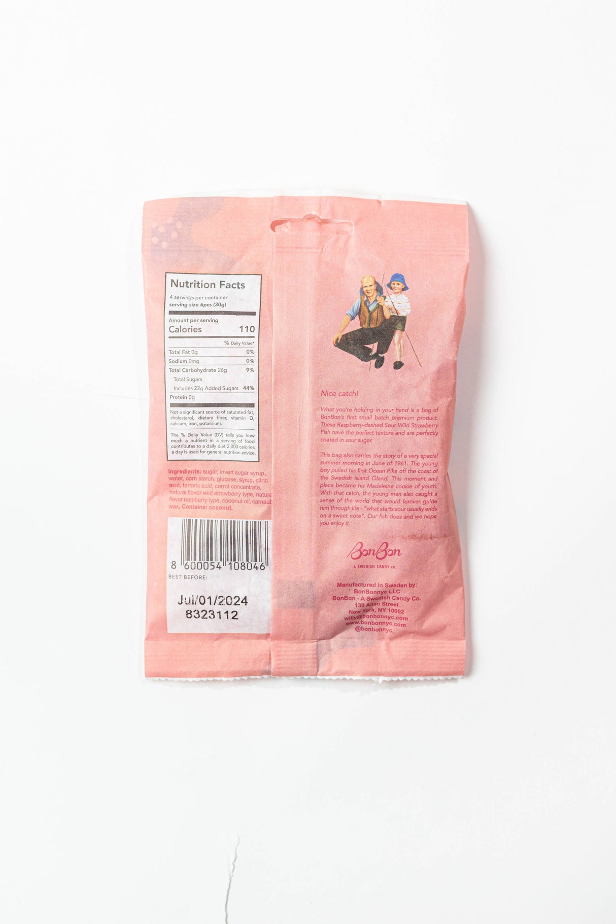The back of the Candy: Bon Bon - Sour Wild Strawberry Fish (150g) pack is pink and shows nutrition facts, a barcode, expiration date, and an illustration with text—ideal for fans of vegan, gluten-free gummy candy.