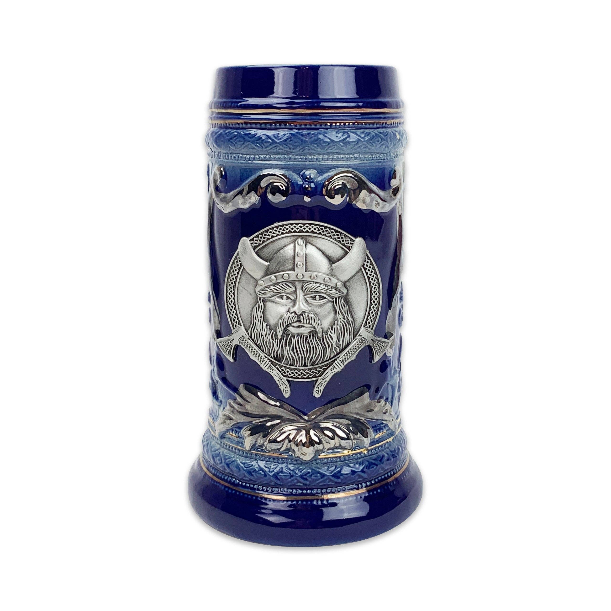 Discover the charm of the Beer Stein: a 20oz blue ceramic masterpiece featuring a silver Viking metal medallion and intricate decorative patterns.