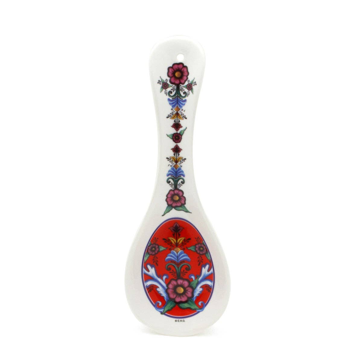 The Spoon Rest: Rosemaling Red is a white ceramic piece with a Scandinavian design, showcasing a floral motif on the handle and intricate Rosemaling Red pattern on the basin, perfect as a stylish kitchen spoon rest.