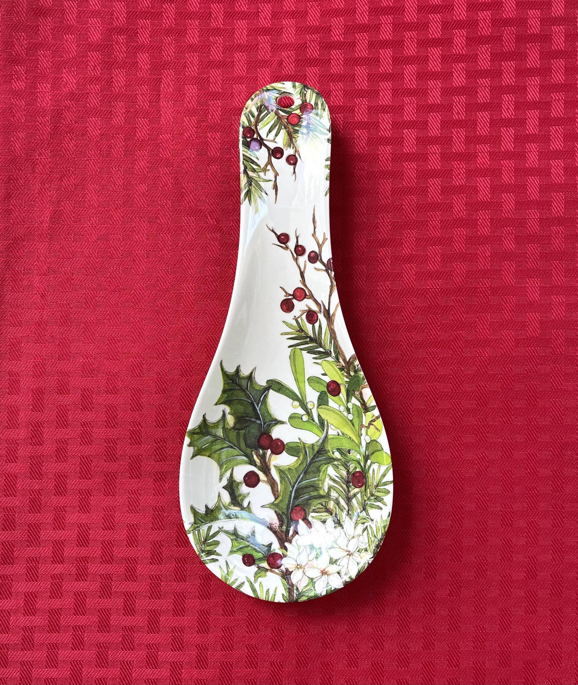 The Holly & Berries Christmas Holiday Spoon Rest, made from eco-friendly bamboo, adds a festive touch to your kitchen with its cheerful holly and berry design—perfect for holiday cooking.