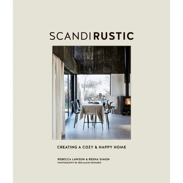 Cover of Scandi Rustic: Creating a Cozy & Happy Home by Rebecca Lawson & Reena Simon features a rustic Scandinavian dining space with large windows and neutral tones. Photography by Benjamin Edwards.