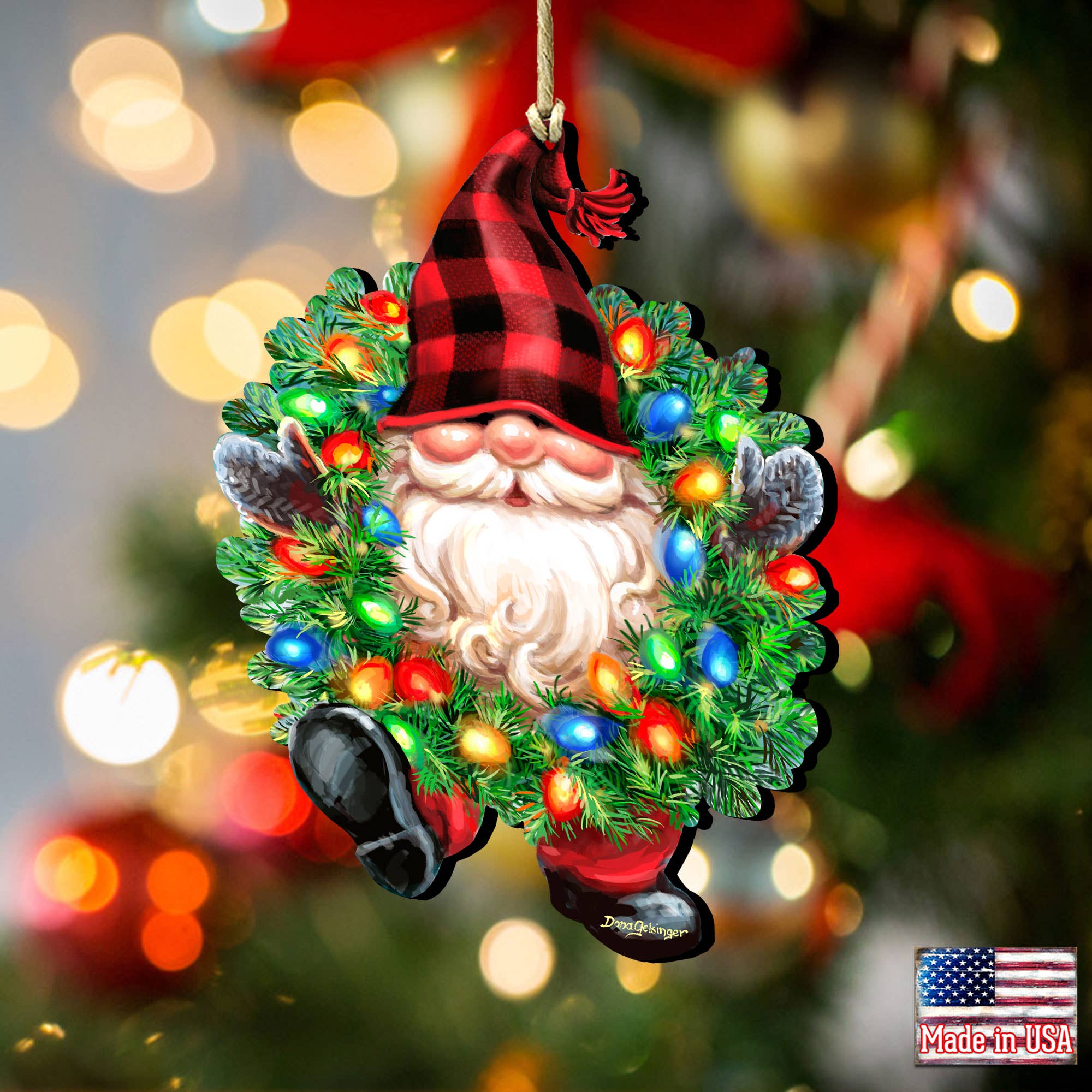 The Bright Light Gnome Ornament by D.Gelsinger (5.5x4.5 in) features a gnome with a red plaid hat in a wreath with colorful lights and an American flag "Made in USA" label, perfect for hanging on your Christmas tree.