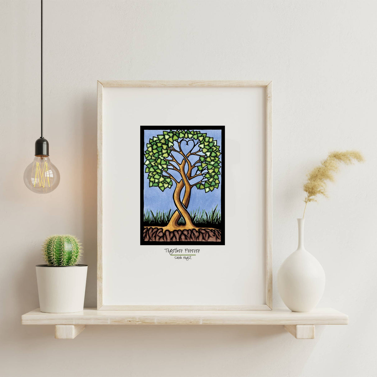 Artwork: Together Forever Tree by Sarah Angst, 8"x10" or 11"x14" giclee print, displayed on a shelf with a potted cactus, white vase with dried grass, and a hanging light bulb.