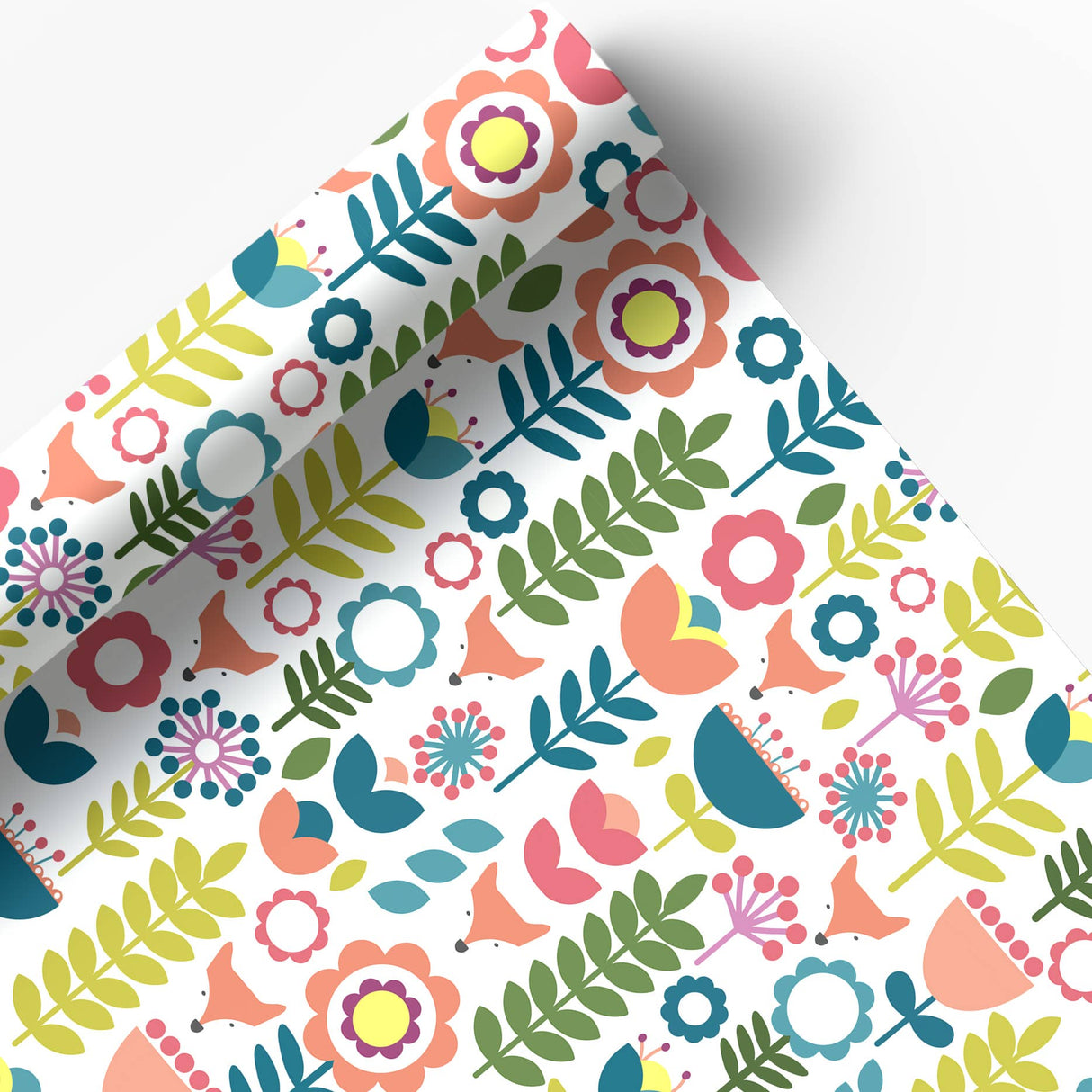 Juniper Blue’s "Tuli" Scandinavian Floral Folk Art Gift Wrap features cheerful pink, yellow, blue, and green flowers on glossy white paper. Includes 2 sheets (20"x29" each), partially unrolled to highlight the modern design.