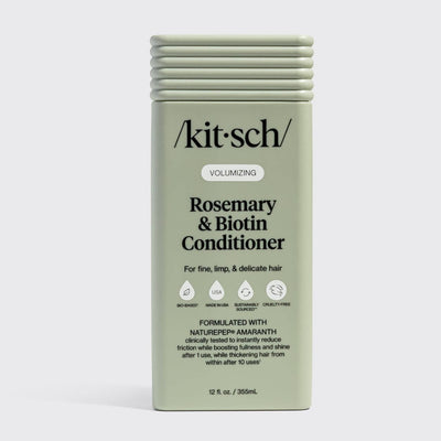 A green rectangular bottle of Hair: Volumizing Rosemary & Biotin Conditioner 12 fl oz, designed for fine, limp, and delicate hair. Enriched with rosemary and biotin to help thicken hair.