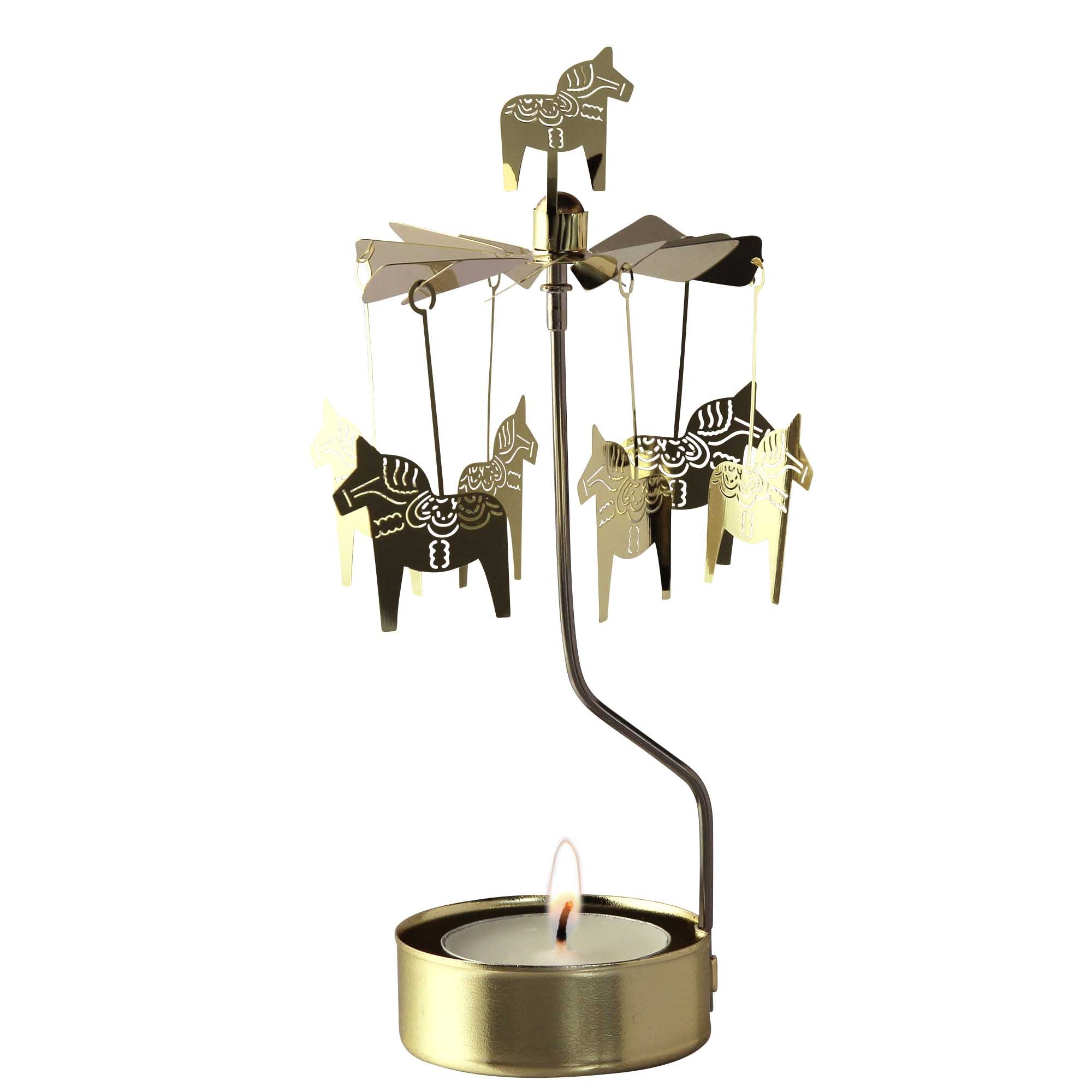 The Candle Holder: Dala Horse Gold Rotary features small horse figures reminiscent of a Dala Horse, spinning gracefully above a lit tealight candle, showcasing elegant Swedish design in brass.