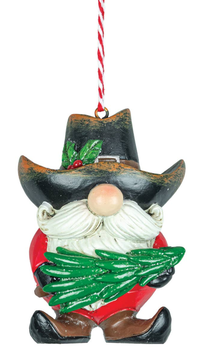 The Cowboy Gnome Ornament (2 Styles) features a whimsical gnome with a white beard, red outfit, black cowboy hat, and green tree branch, hanging from a red and white string—ideal for festive holiday décor.