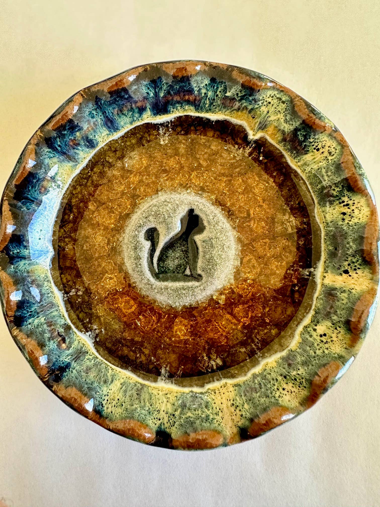 Handmade 4.5" cat dish crafted from recycled glass and clay, featuring a glazed finish in earthy tones with a sitting cat silhouette—ideal for feline lovers or as unique home decor.