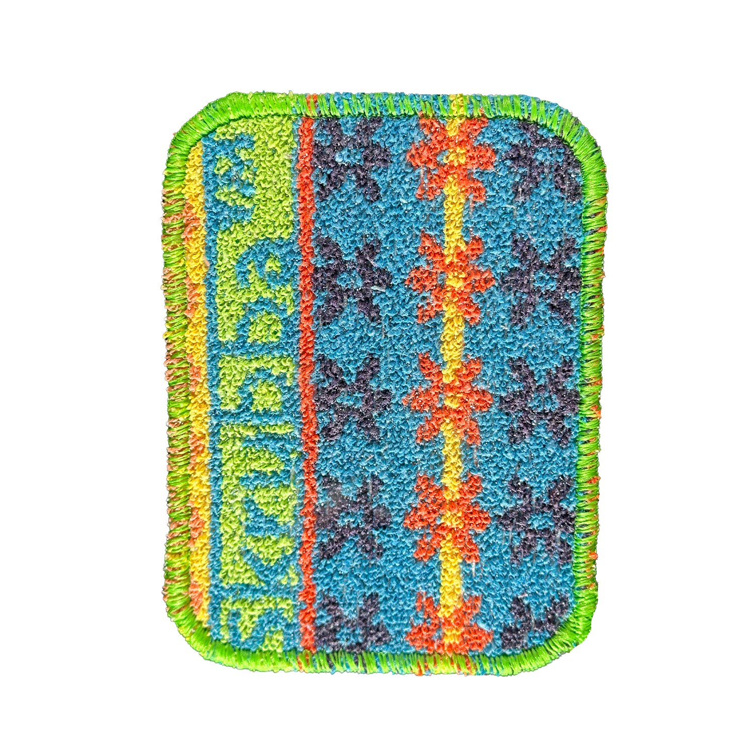 The Scrubby: Vogue Skrubba Cloth features a rectangular embroidered patch with green edges, a blue background, orange flower shapes, a yellow vertical stripe, and green text—ideal for eco-friendly cleaning enthusiasts.