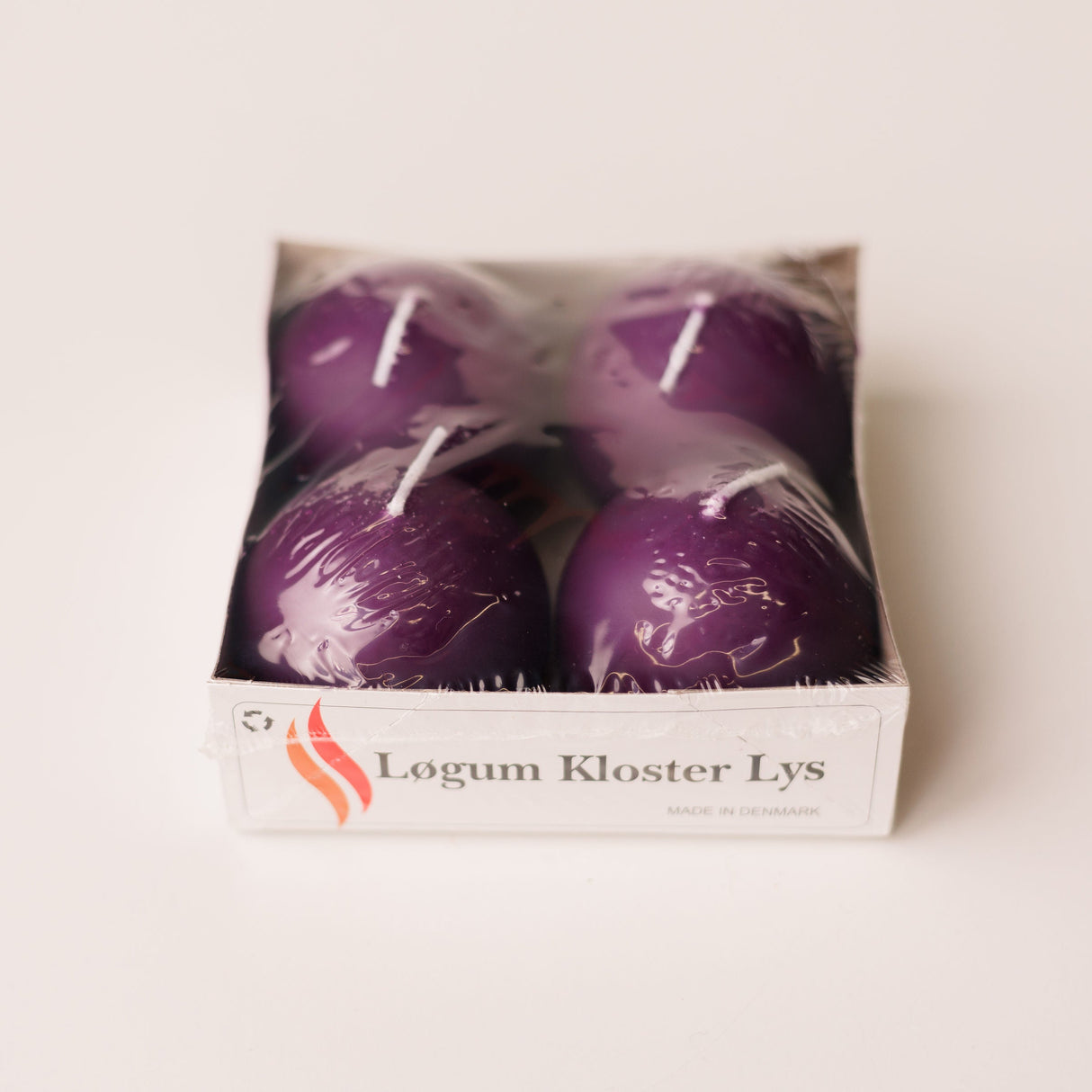 A 4-pack of Logum Kloster Lys 2.5 ball candles—ideal for creating HYGGE at home—comes wrapped in plastic and boxed, perfect for cozy decor.