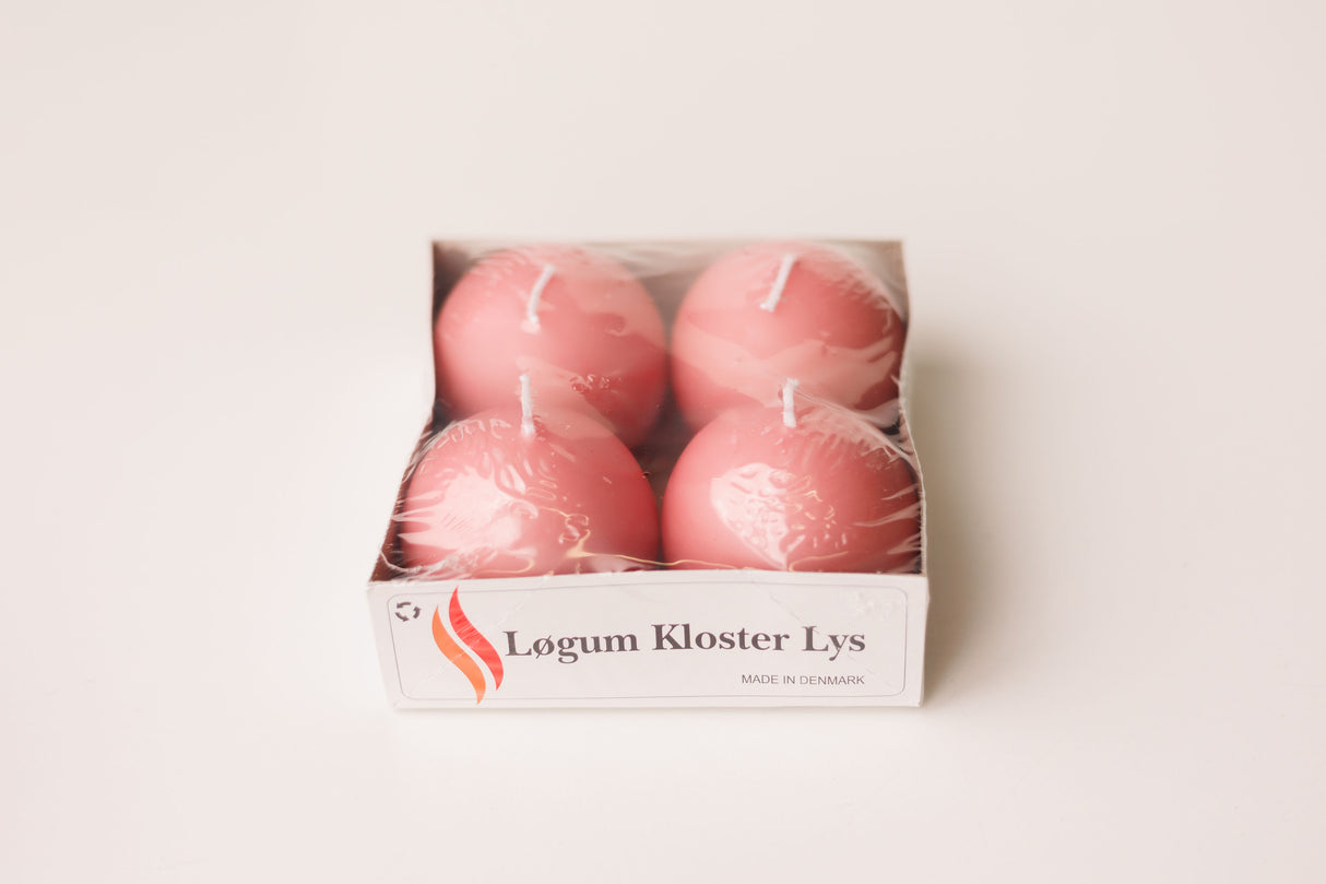 The Logum Kloster Lys 2.5 Ball Candles (4 Pack) features four round pink candles, made in Denmark, wrapped in plastic and labeled for a touch of HYGGE—perfect for cozy decor. Shown against a white background.