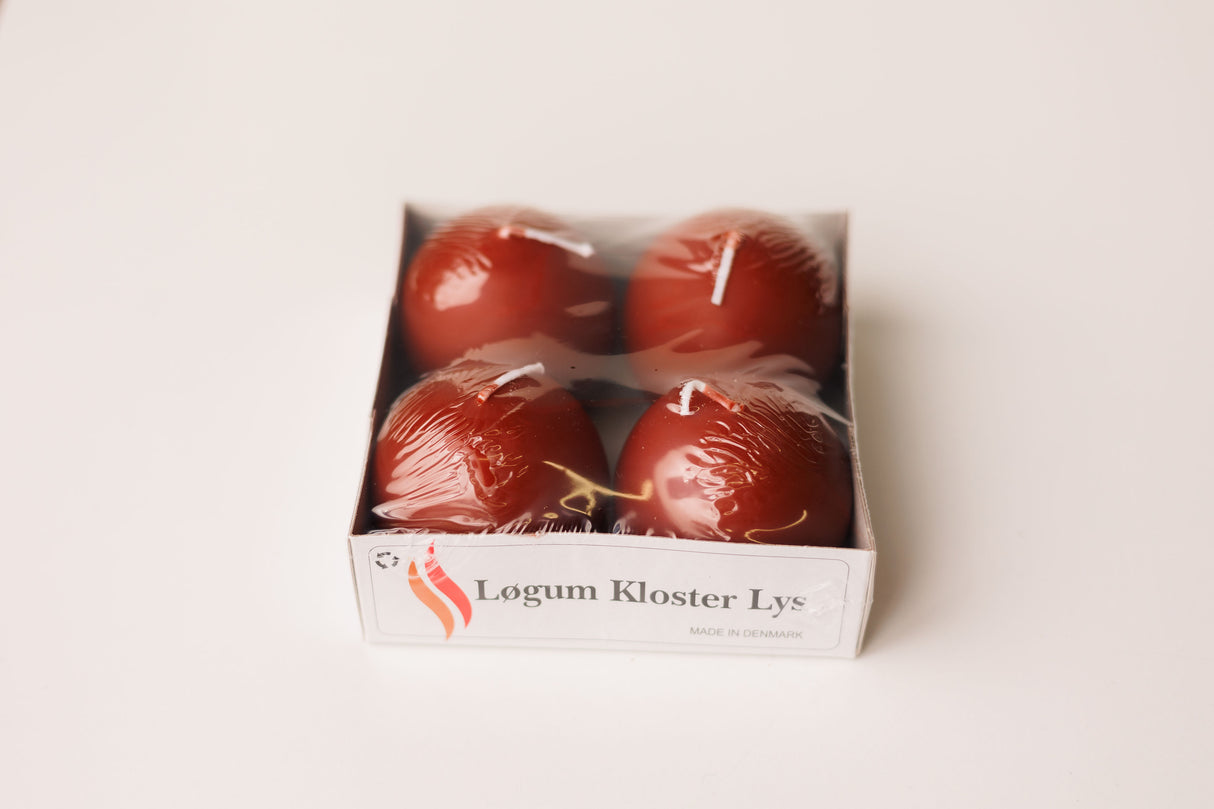 A 4-pack of Logum Kloster Lys 2.5 red ball candles from Denmark, wrapped in plastic, displayed on a white background.