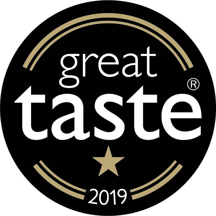 A black and gold Great Taste 2019 award logo with a star beneath adds elegance to the luxurious MilkBoy Swiss Alpine Milk Chocolate with Caramel & Sea Salt Snack Size Bars.