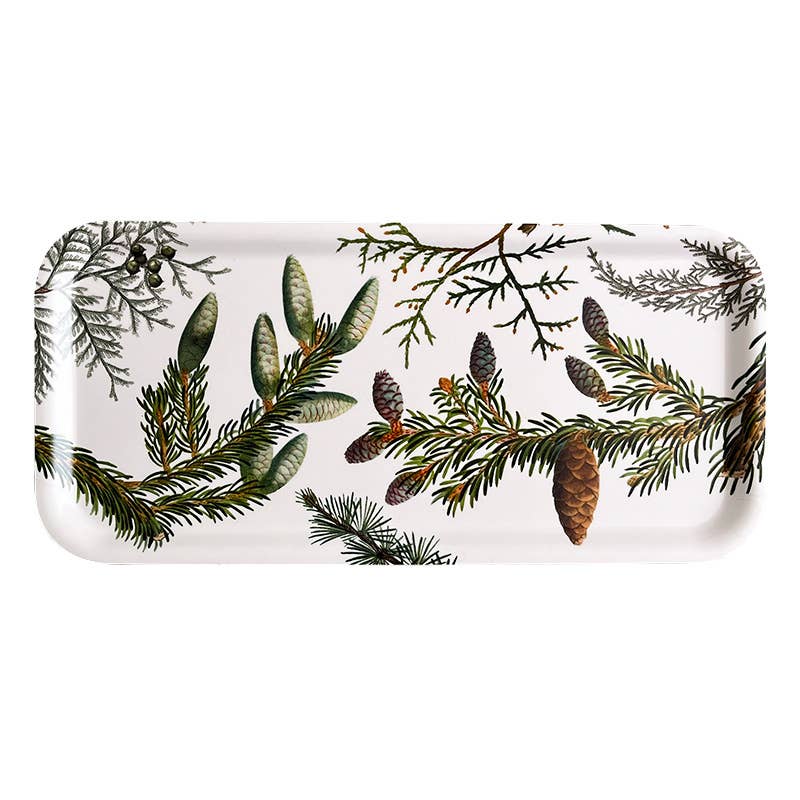 The Tray: Pine Trees is a 6x12 inch white wood serving tray, made in Sweden for Koustrup Co, featuring illustrations of pine branches, pinecones, and evergreen foliage.