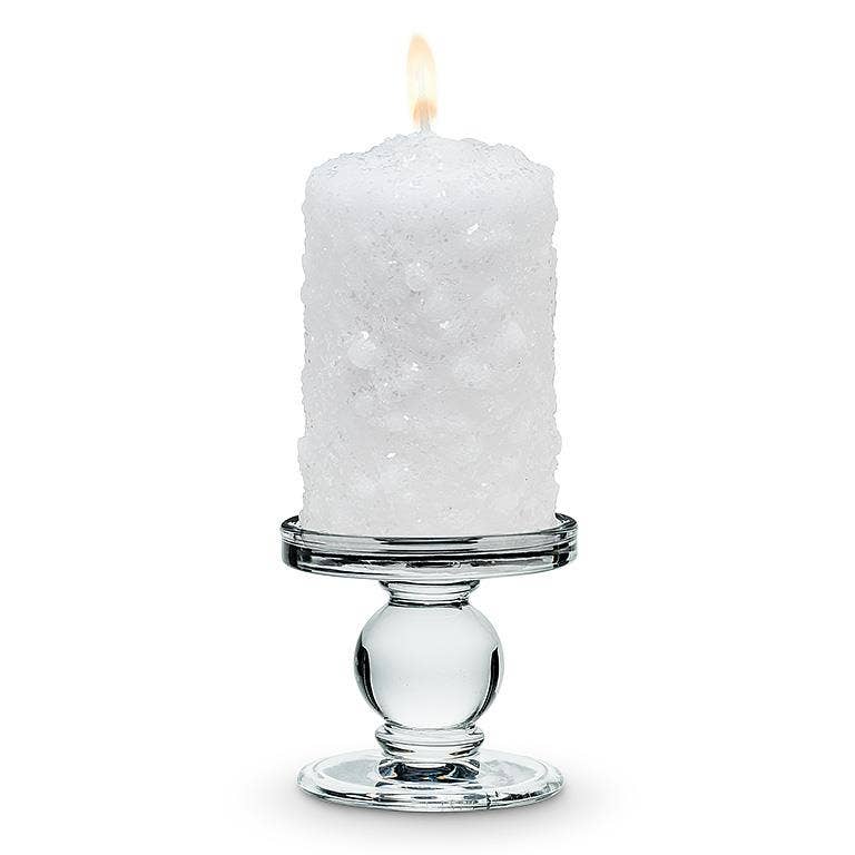 A lit white textured pillar candle rests on the Small Reversible Candleholder-2.5"H against a plain white background.