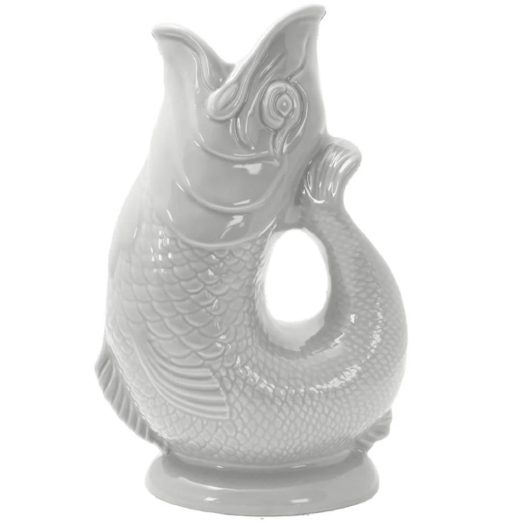 The Classic Gluggle Jug is a white ceramic fish-shaped pitcher with detailed scales, an open mouth, and a handle-shaped body—ideal for adding classic British charm to your kitchen decor.