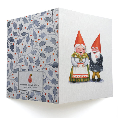 The Card Pack: Happy Gnome Notes features folded illustrated note cards with a floral pattern on one side, two smiling gnomes in traditional attire on the other, and is printed on recycled paper—perfect for sending cheerful greetings.