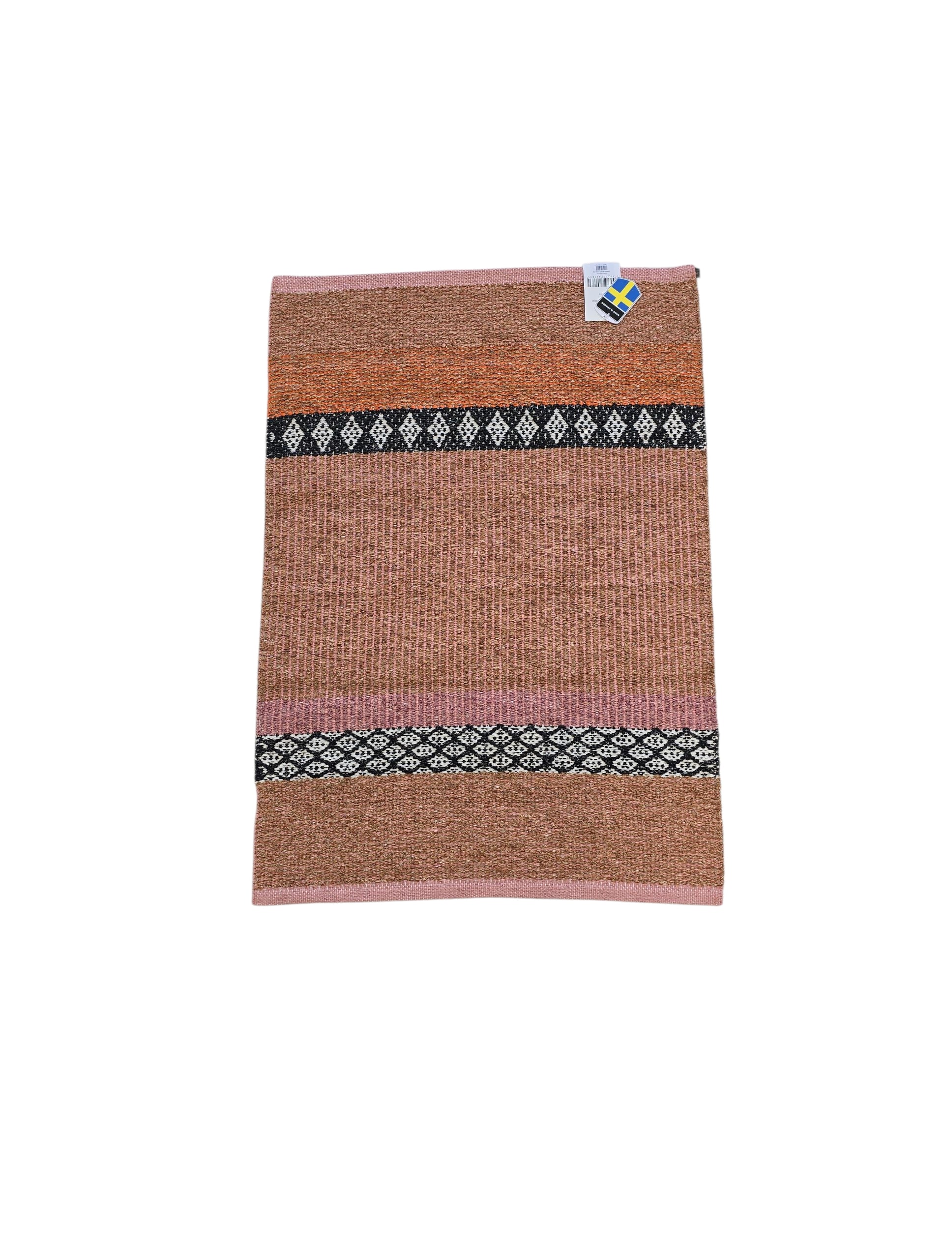 The Horredsmattan Forest Rust cotton/vinyl rug features brown, pink, and black geometric patterns and a small tag at the top right corner.