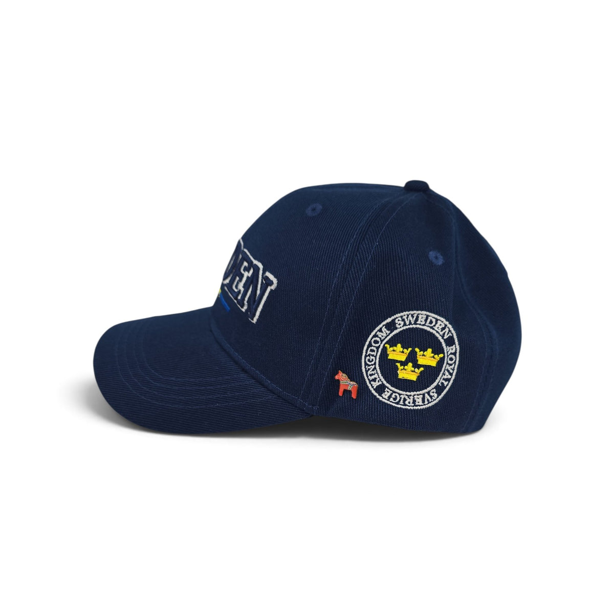 Navy blue cap with SWEDEN embroidered on the side, a circular Sweden emblem patch with yellow crowns, and a small red Dala horse lapel pin.