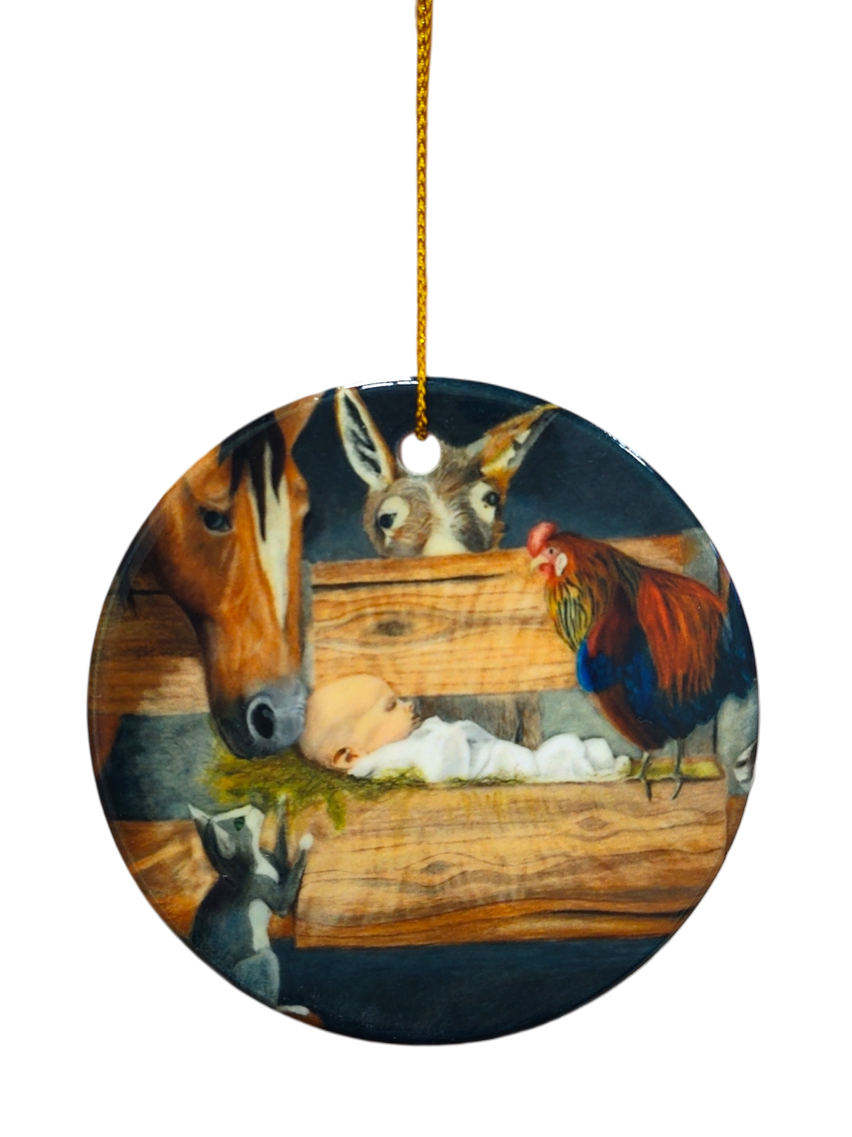 The Ornament: Manger Scene with Barn Animals and Baby Jesus Ceramic Ornament features baby Jesus in a manger, surrounded by a horse, donkey, rooster, and goat, with a gold hanging string at the top.
