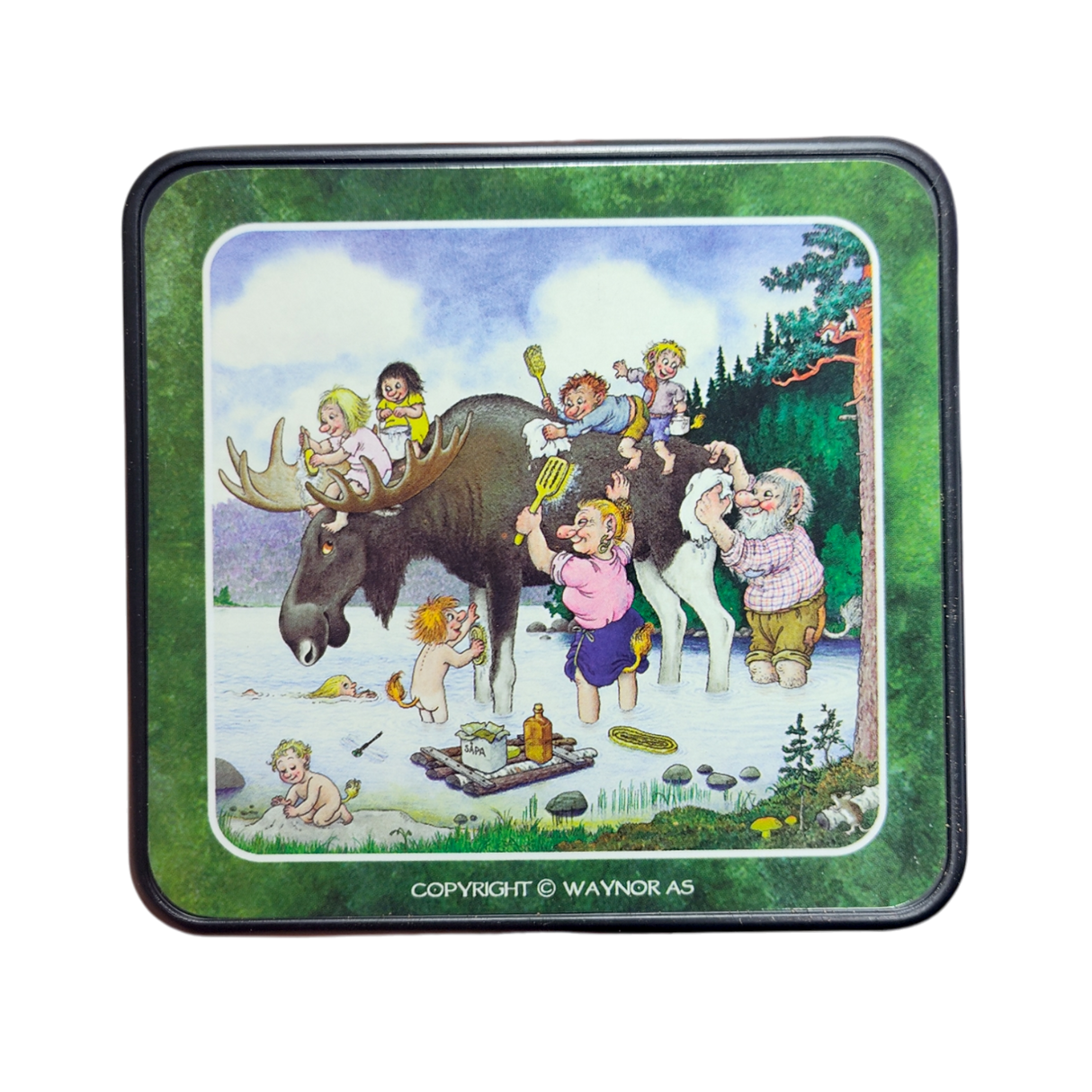 Whimsical scene inspired by the Rolf Lidberg Collection: children and adults play around a moose by a lake with picnic items, set among trees. Perfect for fans of Scandinavian folklore—featured on Troll Norway Rolf Lidberg Collection Coasters (4-Pack).