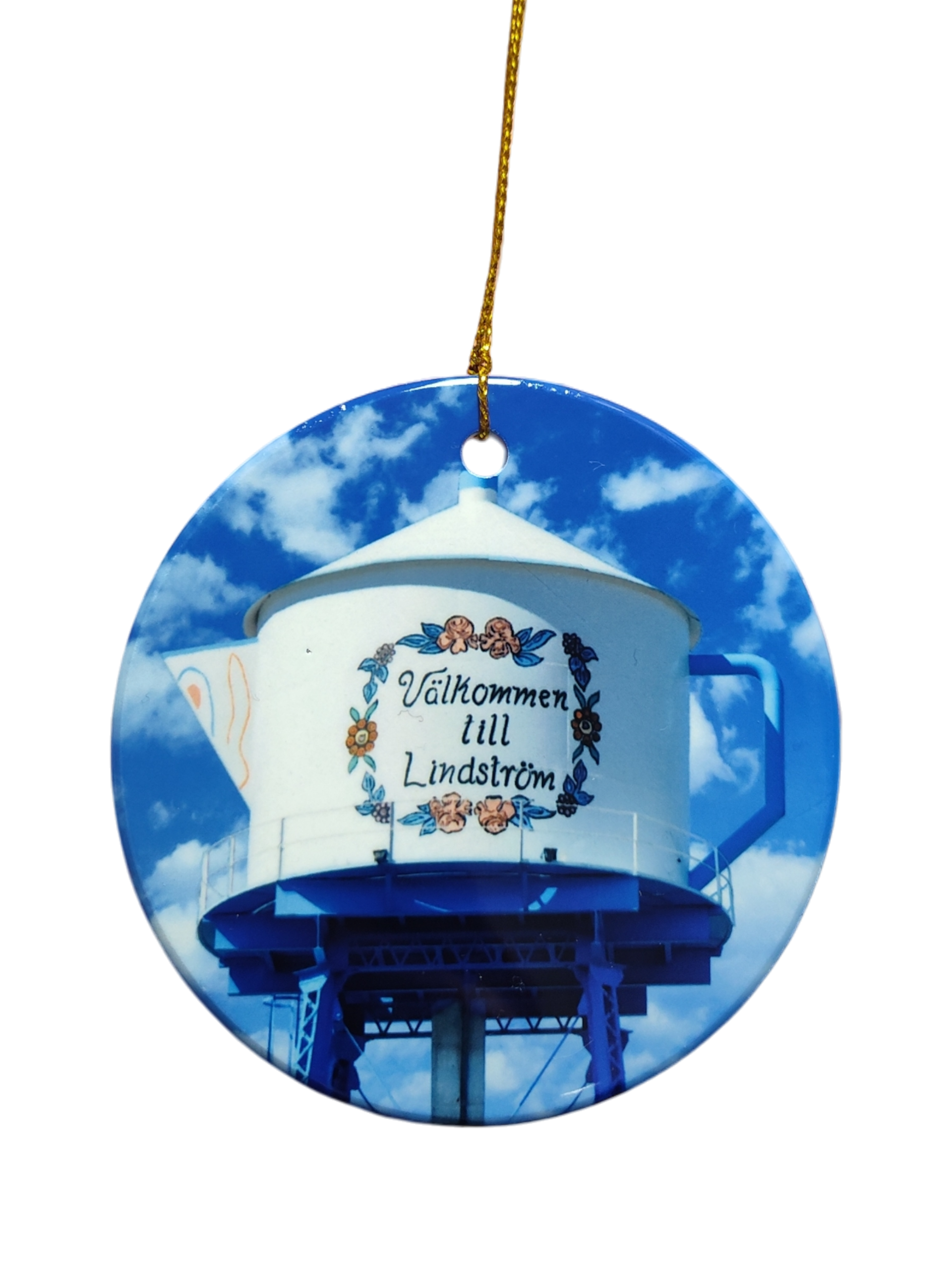 The Ornament: Valkommen till Lindstrom Ceramic Ornament features a water tower painted as a teapot with “Välkommen till Lindström” in Swedish, celebrating the city's Scandinavian heritage against a blue sky.