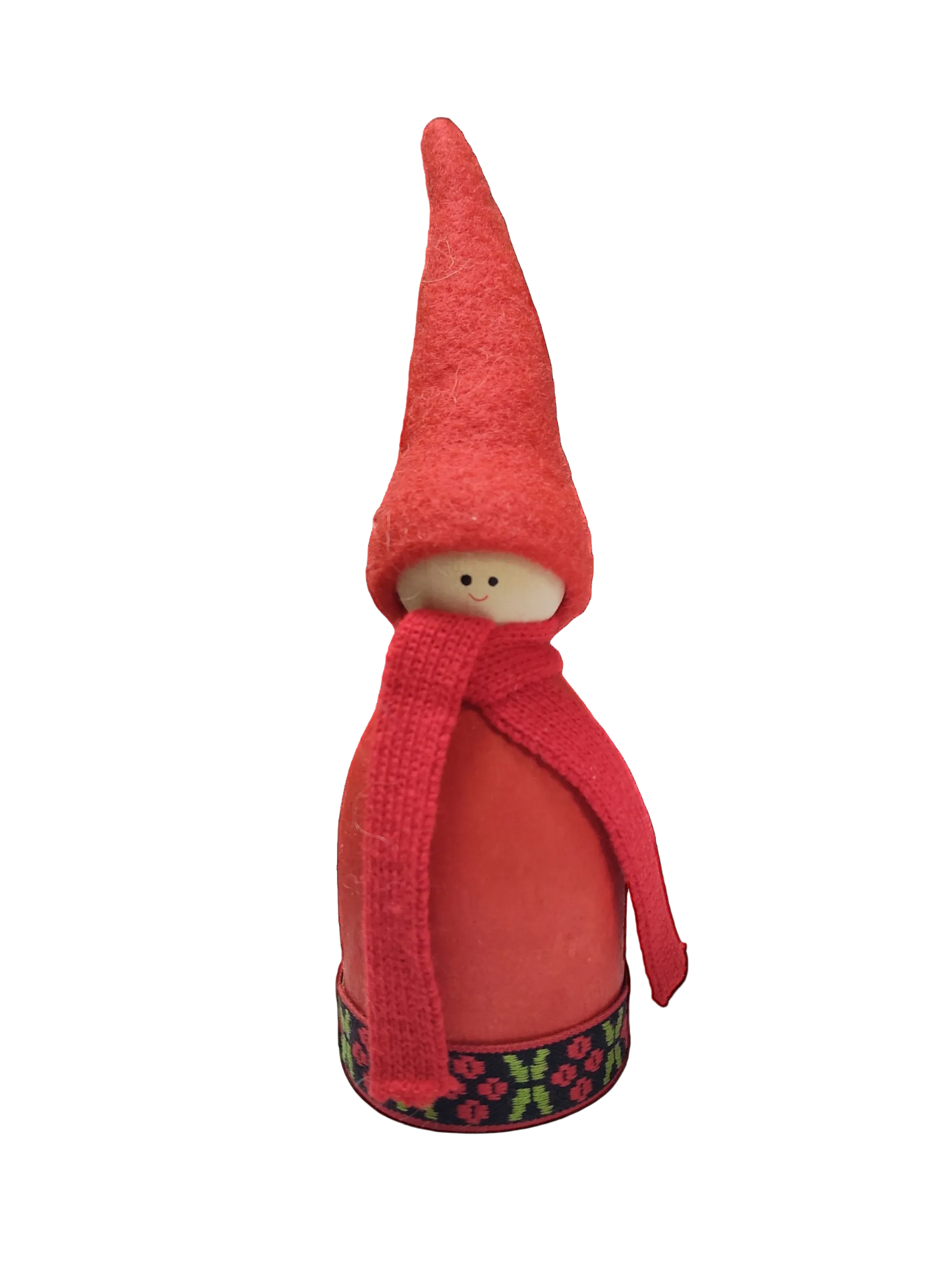 The Figurine: Tomte Figurine with Red Hat is a small Swedish handmade piece featuring a red felt hat, red scarf, and simple face, standing on a base with a decorative pattern.
