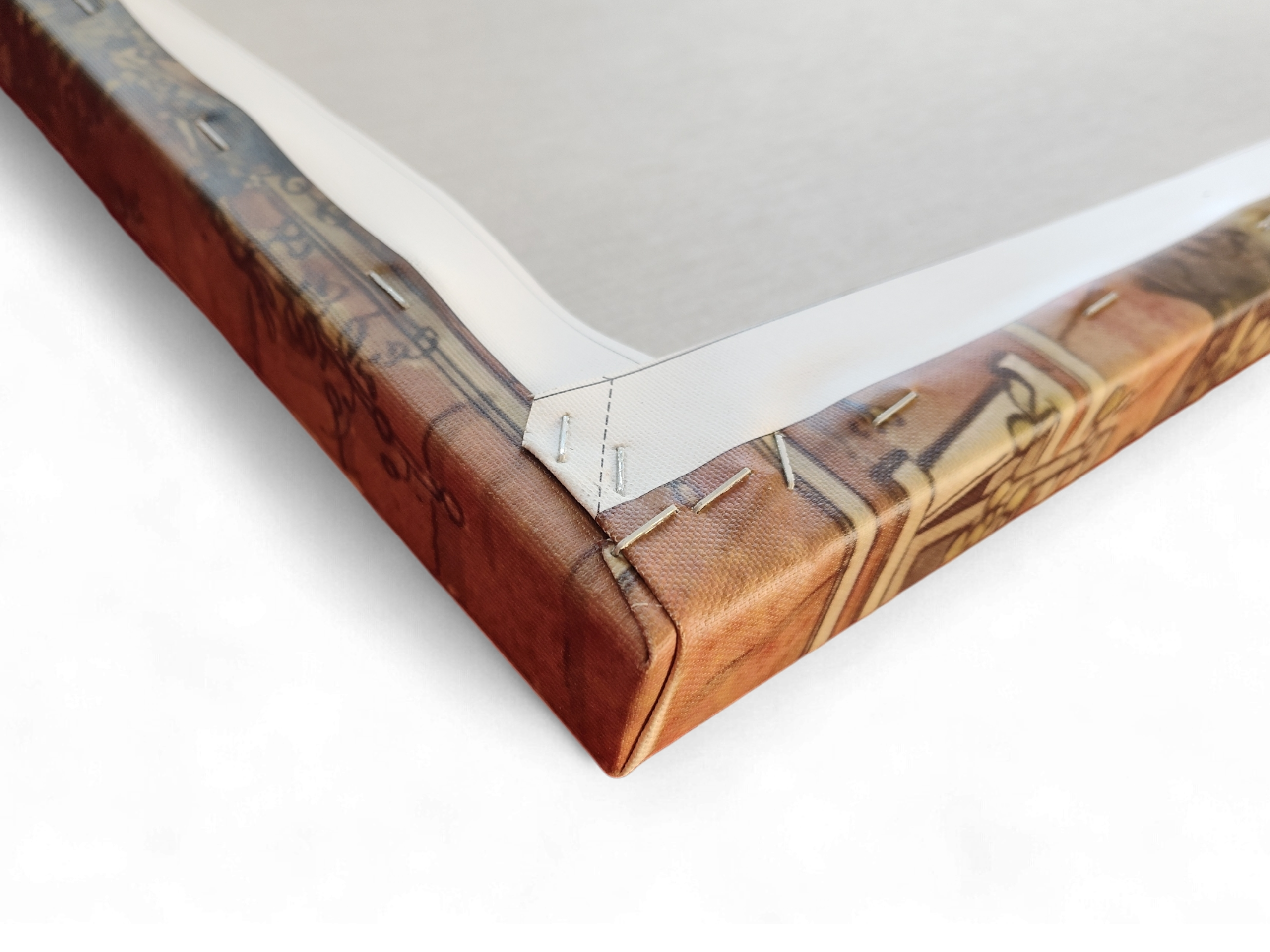 Close-up of the back corner of "Artwork: Breakfast Under the Big Birch Carl Larsson 1853–1919 Print on Canvas," showing folded fabric stapled to the wooden frame—highlighting its premium craftsmanship.