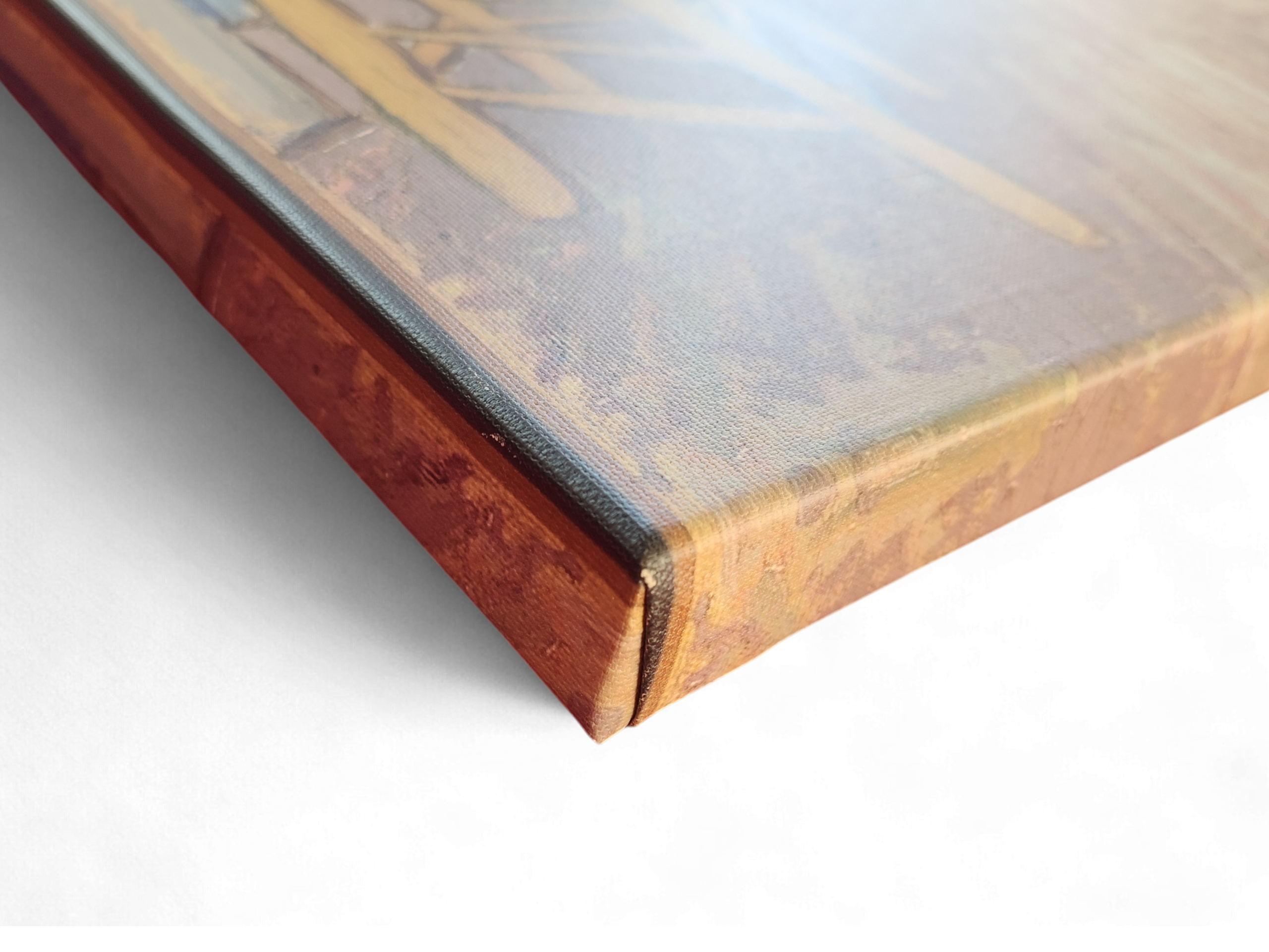 Close-up of the corner of "Artwork: Bedroom in Arles Vincent Van Gogh 1853 - 1890 Print on Canvas" wall art with a wooden frame, resting on a white surface.