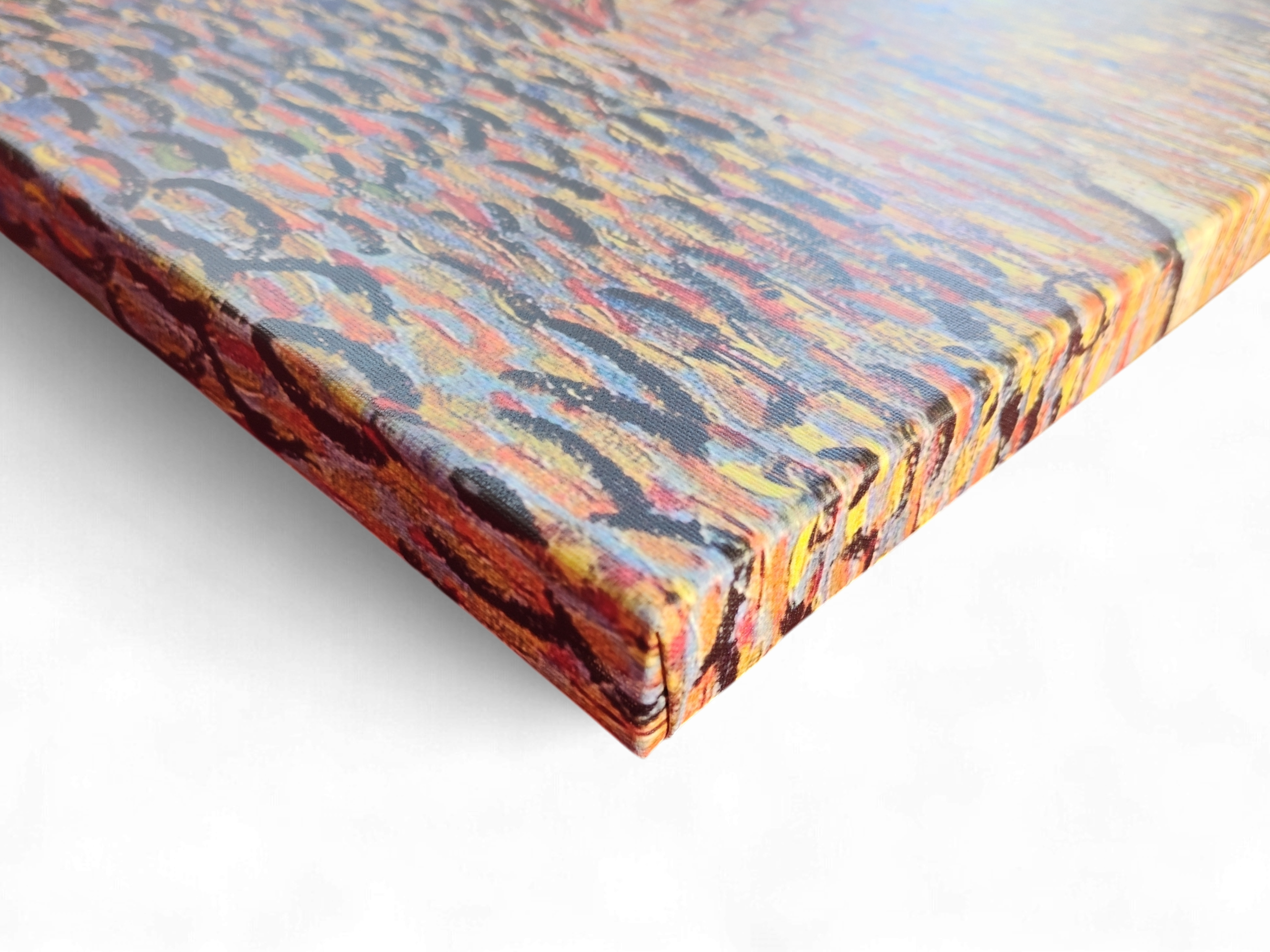 Close-up of the corner of a stretched canvas print titled "Café Terrace at Night" by Vincent Van Gogh (1853–1890).