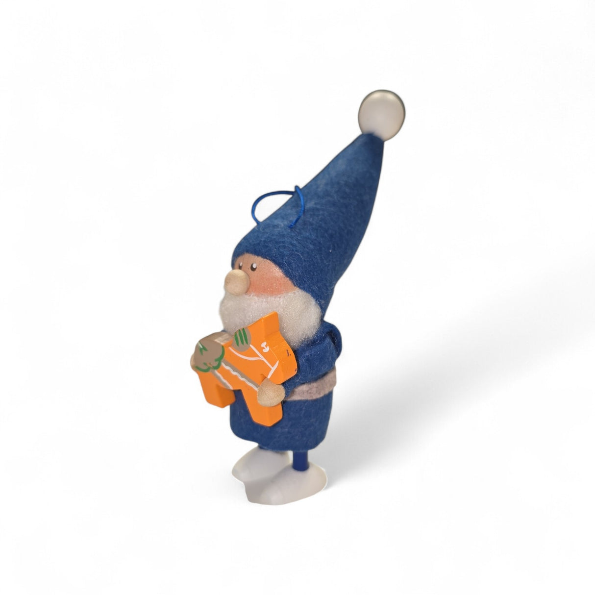 A small figurine named "Santa Gnome with Swedish Dala horse" features a Swedish Santa gnome in a blue outfit and tall hat, holding an orange Dala horse, standing on a white surface.