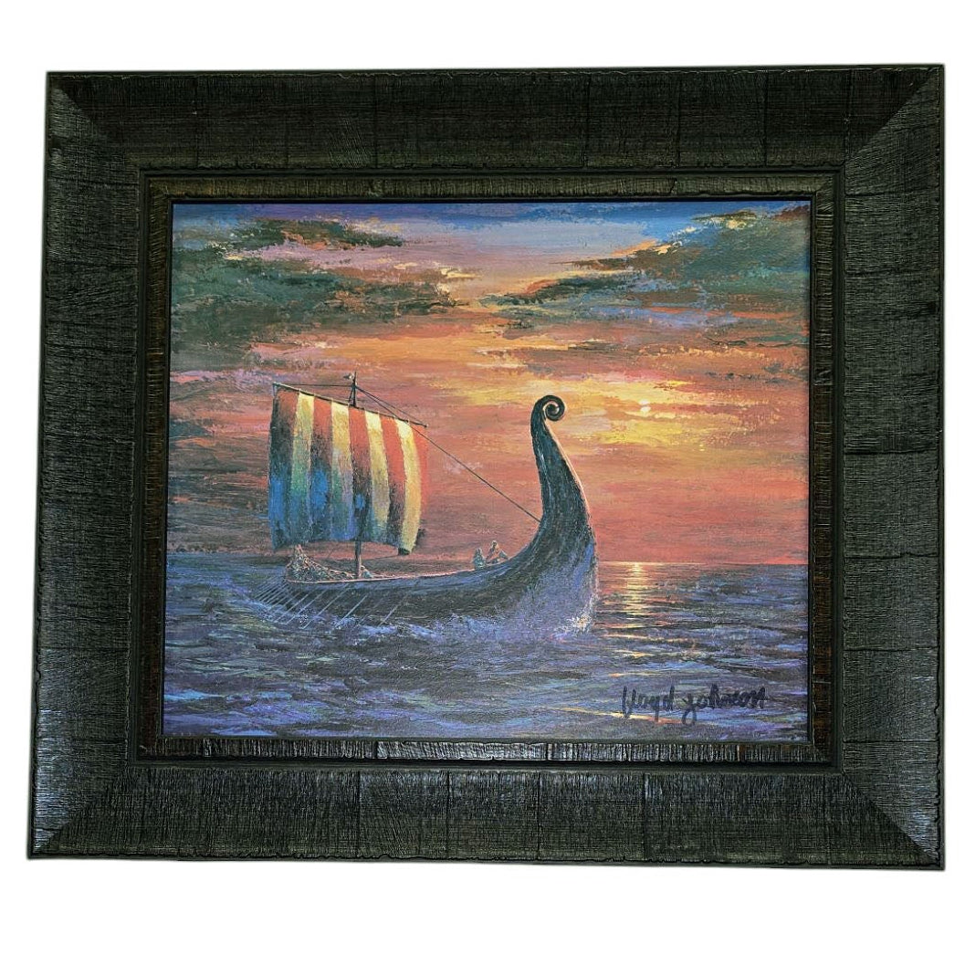 The Scandinavian artwork Final Light At Sea by Floyd Johnson features a Viking ship with a colorful striped sail gliding across the sea at sunset, displayed in an acrylic with dark brown frame.