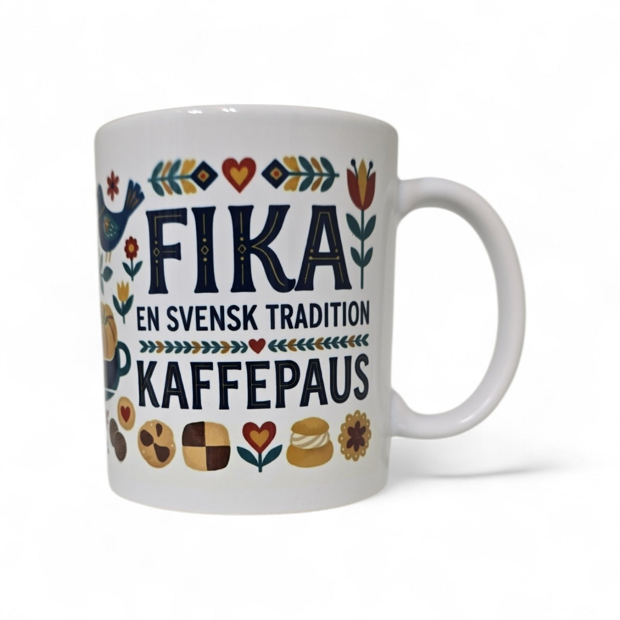 The Mug: Fika — En Svensk Tradition Kaffepaus 11oz ceramic coffee mug from Swedish Gift Store features colorful flower, bird, and pastry illustrations with the text "FIKA EN SVENSK TRADITION KAFFEPAUS"—a great gift for fika lovers.