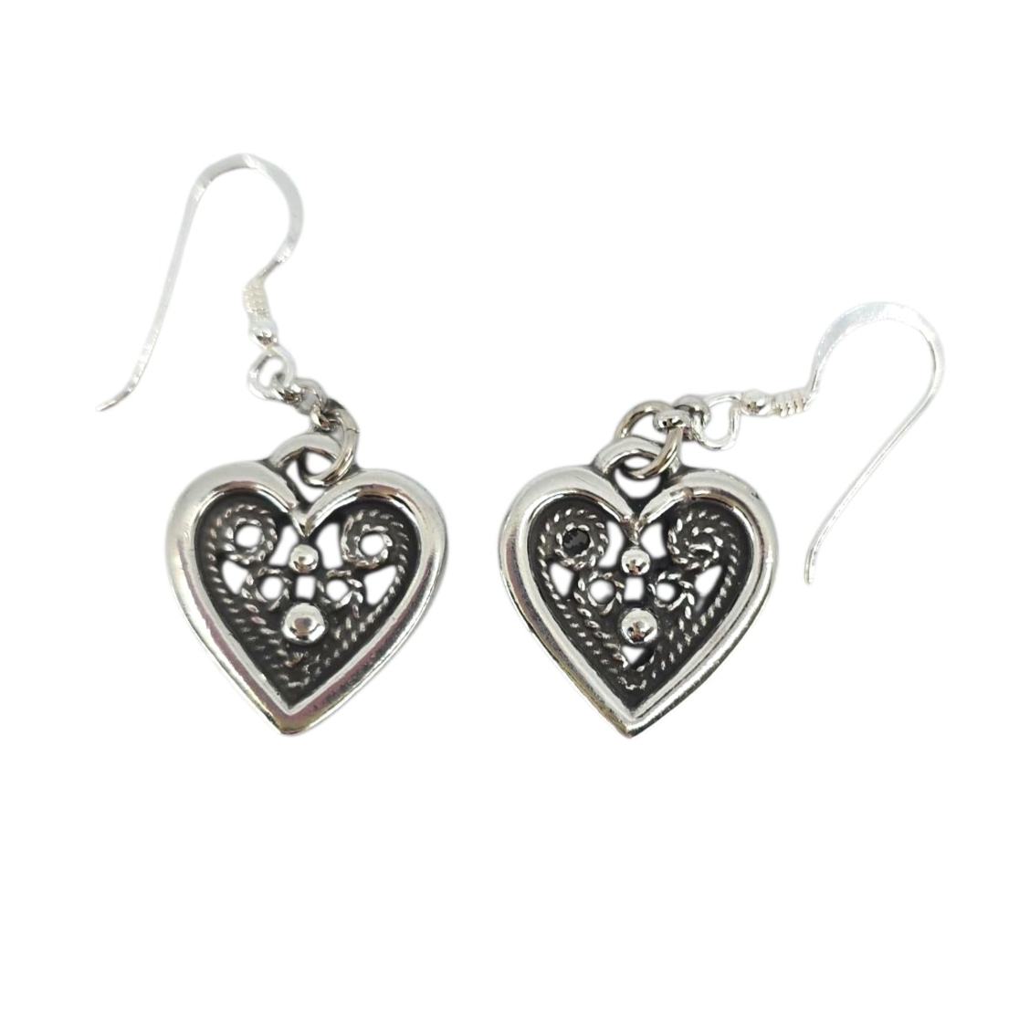 Heart-shaped pewter earrings with sterling silver hooks by Hillestad of Norway, inspired by Scandinavian jewelry traditions and featuring intricate filigree and bead detailing.