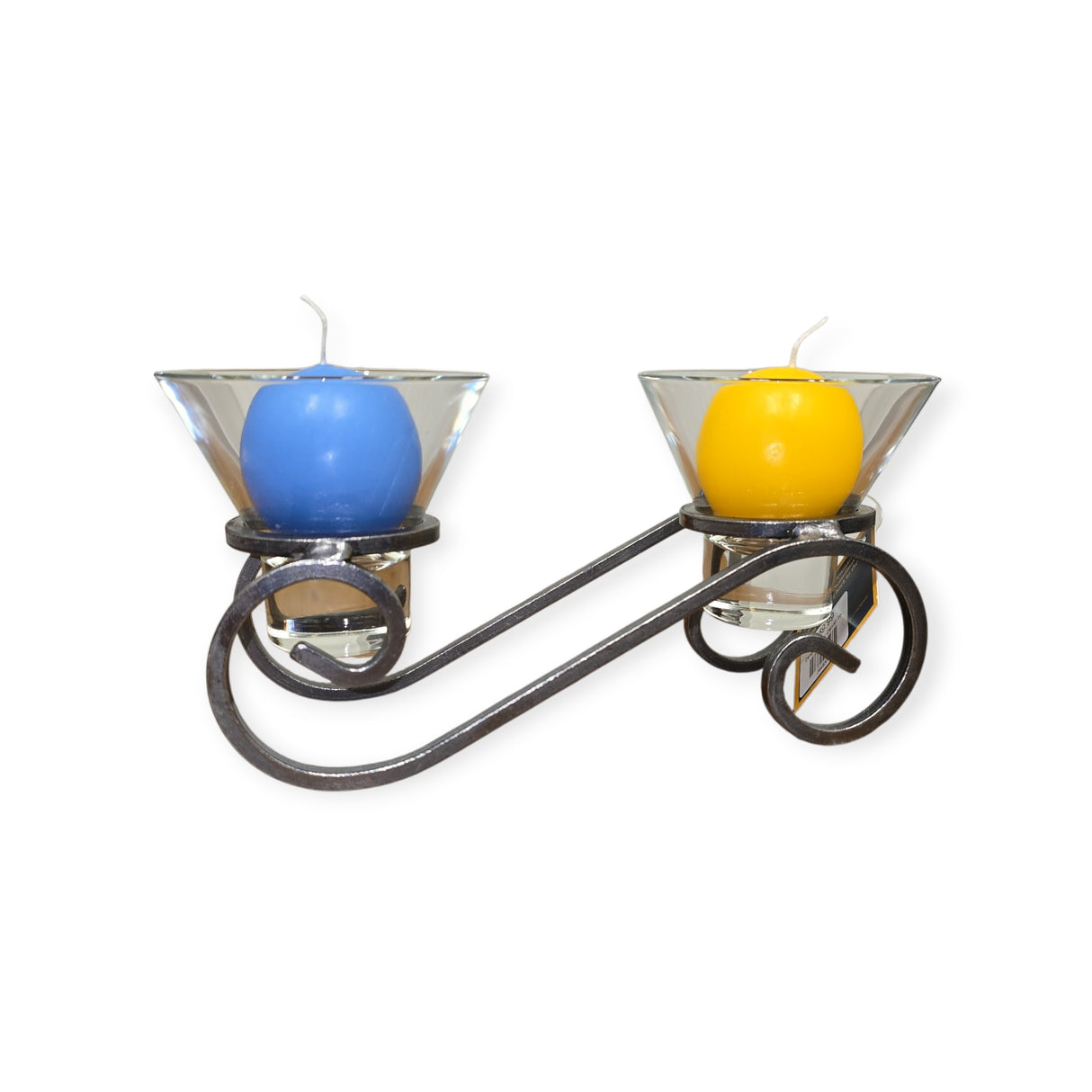 A metal candle holder with a swirled design holds two glass cups, each featuring a Logum Kloster Lys 2.5" Ball Candle in blue and yellow—adding a Scandinavian touch to your décor.