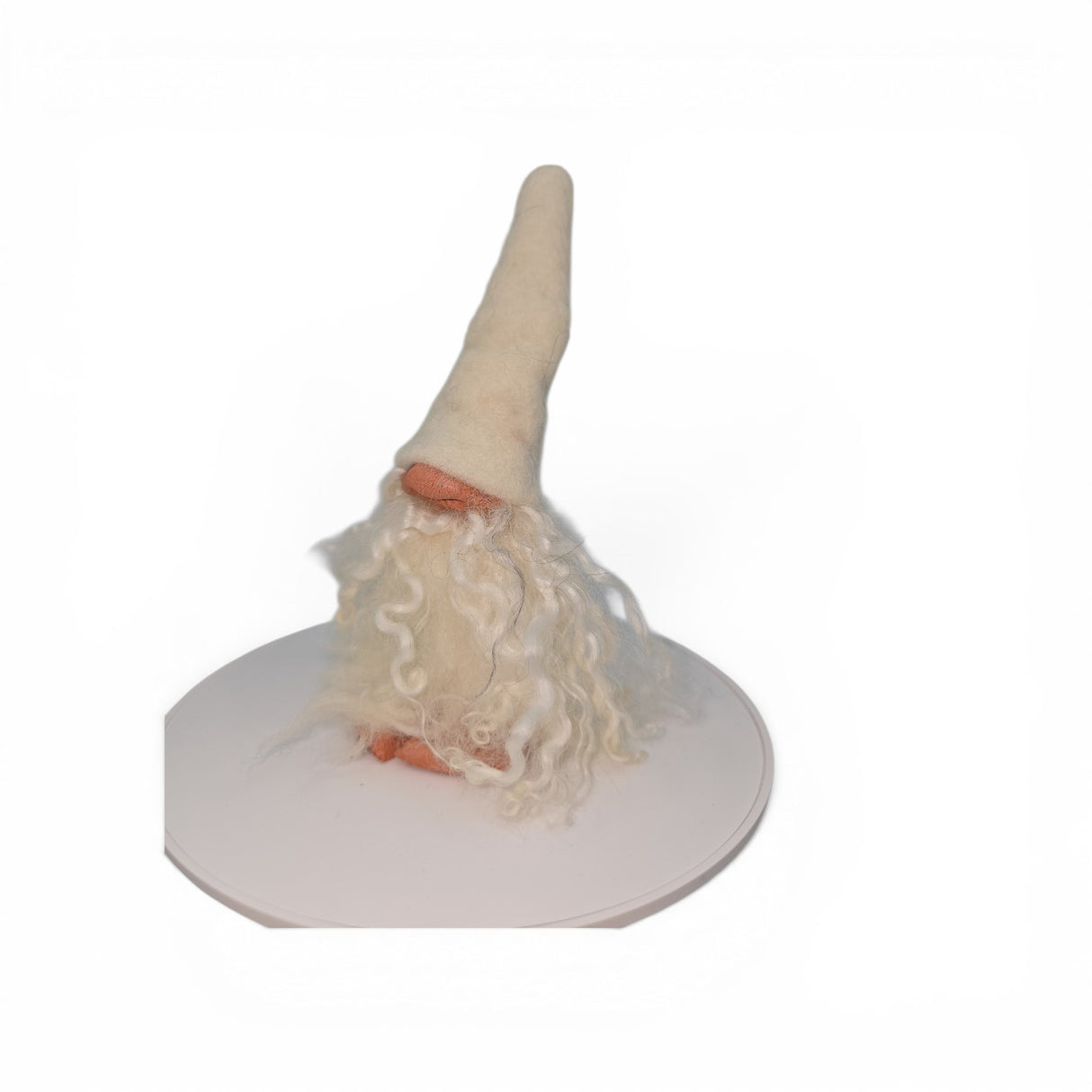 A delightful "Foot Tomte" gnome figurine by Gumselids of Sweden, distributed by Talla Imports, featuring a tall, pointed white hat, long curly white beard, and charming clay nose and feet. Standing 6" to the tip of its hat on a rounded white surface against a plain white background, this handcrafted Swedish Tomte brings the warmth of Scandinavian tradition to any decor.