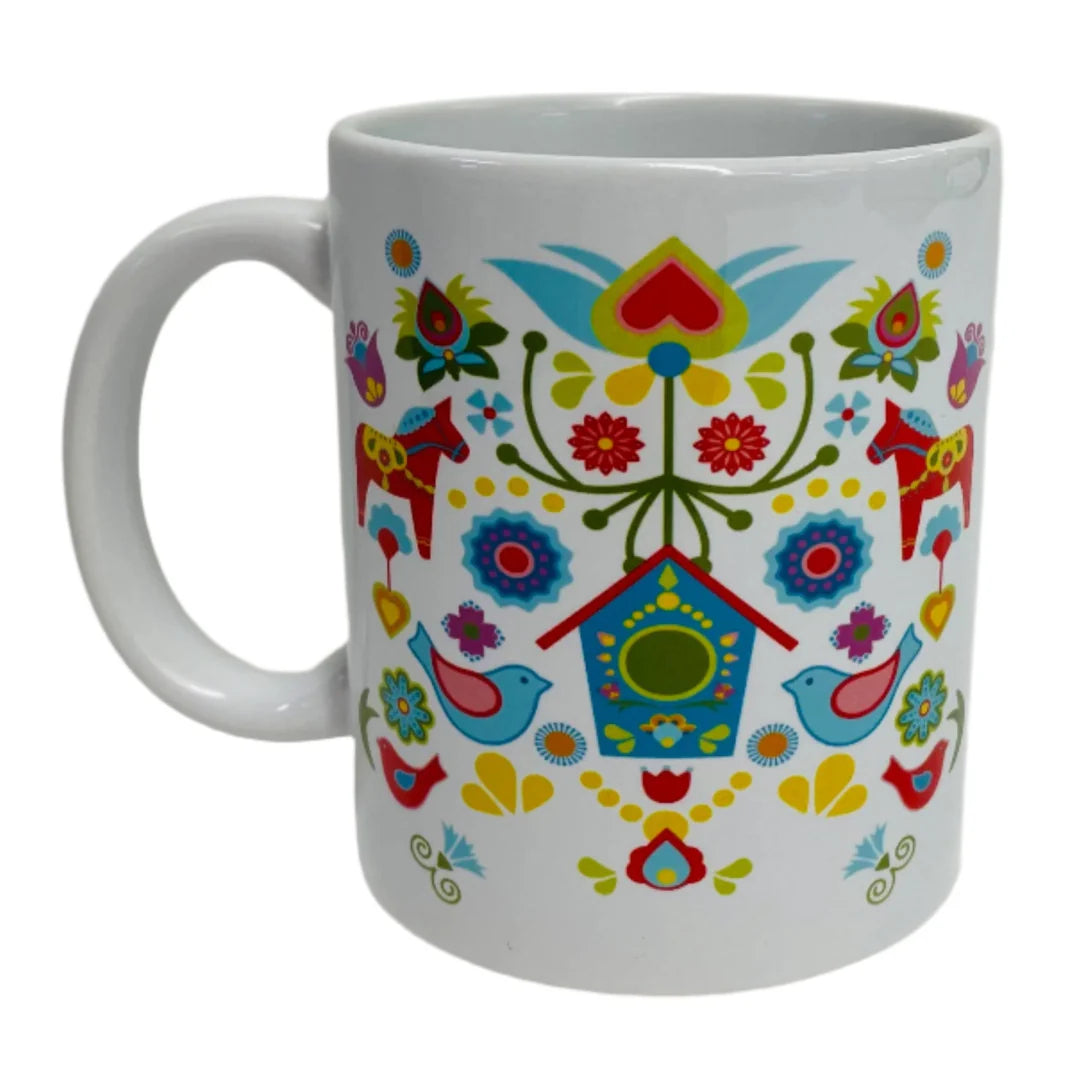 The Mug: Dala Horse with Bird House coffee mug features colorful Scandinavian folk art with birds, flowers, a birdhouse, and two red Swedish Dala Horses—ideal for fans of Nordic design.