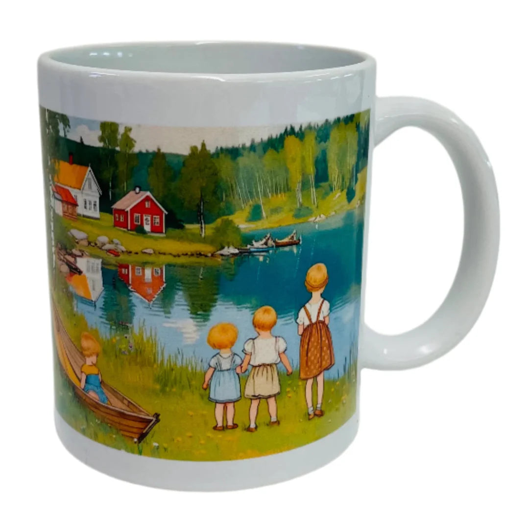 The Mug: Children by the Lake in Summer Coffee Mug features an illustration of four children by a lakeside with red and white houses, evoking the charm of a Scandinavian summer. Inspired by Carl Larsson, it's perfect for your favorite hot drink.