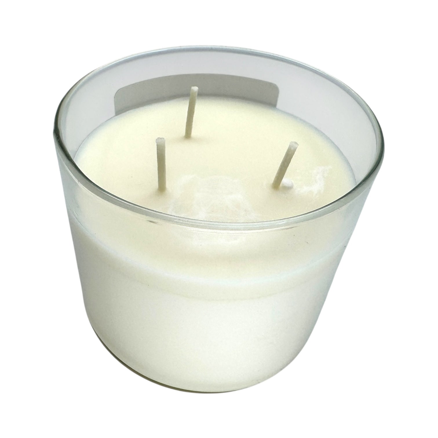 The Candle: Nordic Balsam - Winter Forest Candle is a white soy blend candle with three wicks in a clear glass container, displayed from above on a white background.