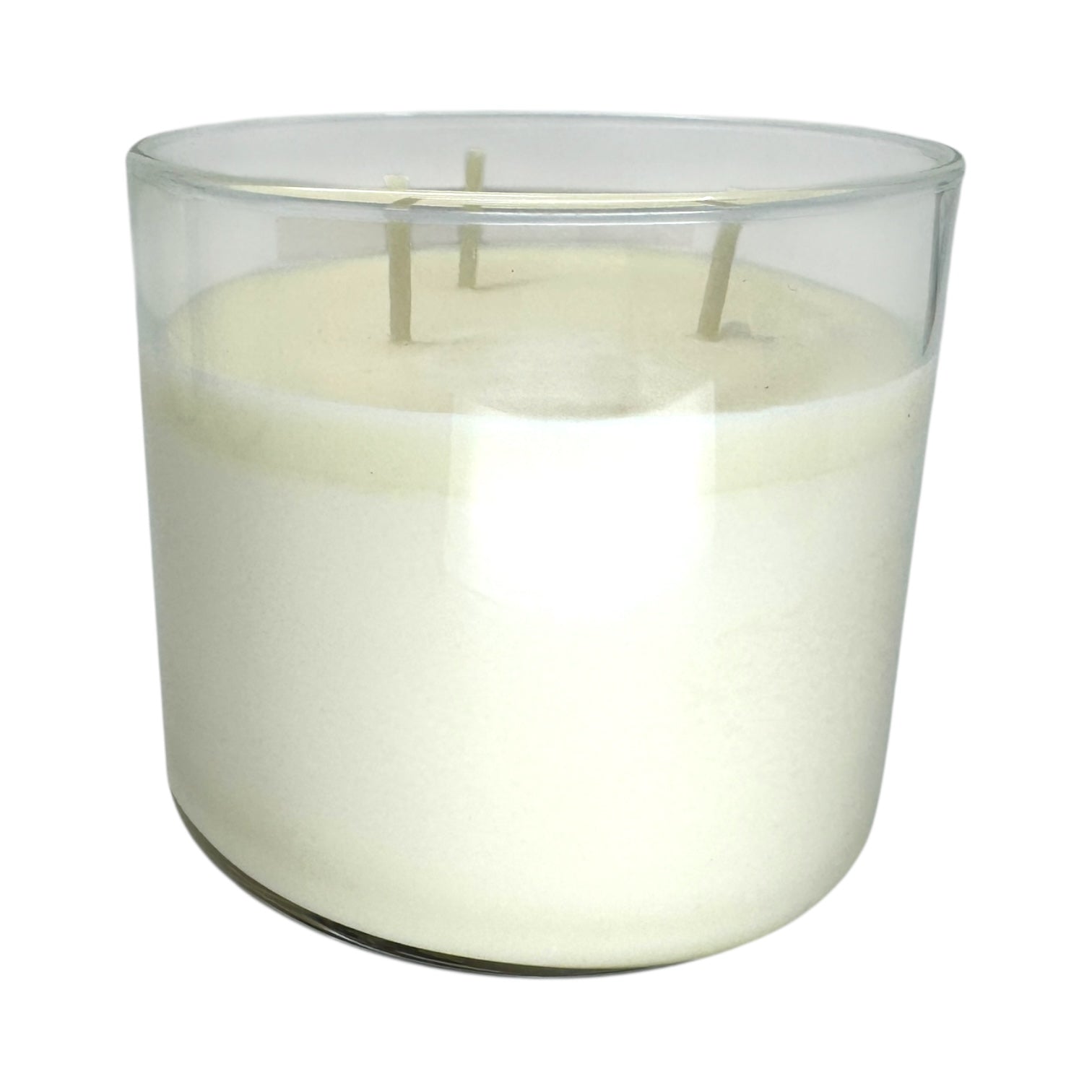 A clear glass container holds the Candle: Nordic Balsam - Winter Forest Candle, showcasing three unused wicks against a plain white background.