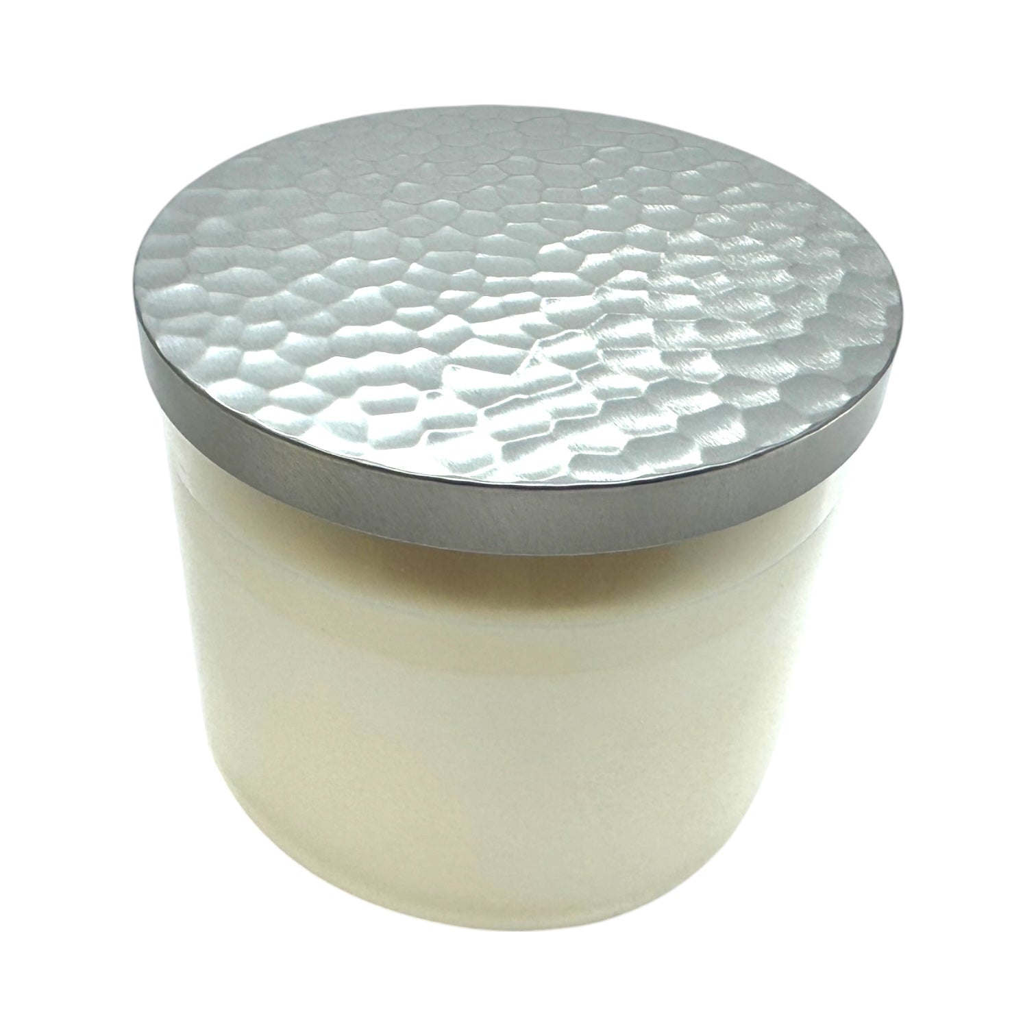 The Candle: Nordic Balsam - Winter Forest Candle is a white soy blend in a glass jar with a metallic, hammered-texture lid, displayed against a plain white background.