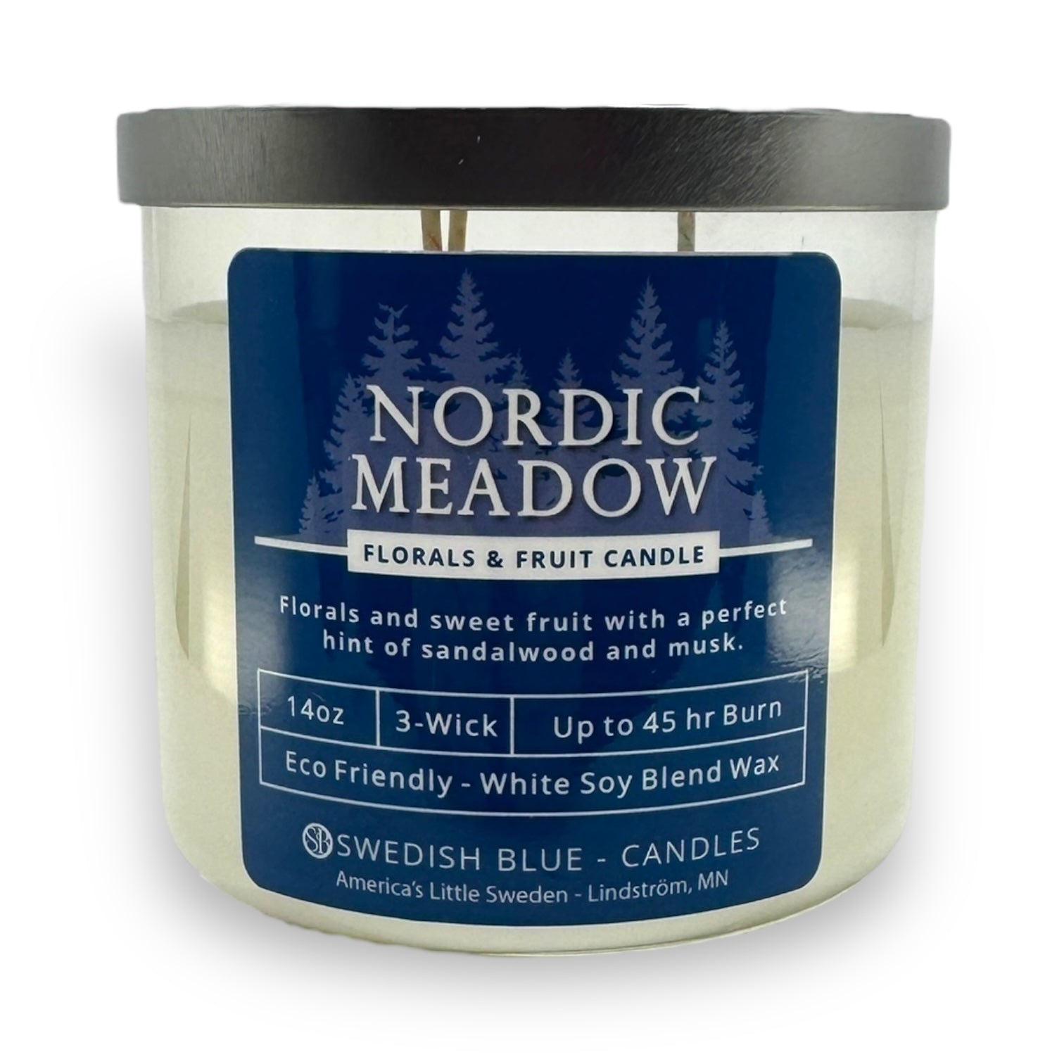 The Nordic Meadow – Florals & Fruit Candle is a 14 oz, 3-wick candle in a clear jar with a blue label, crafted from an eco-friendly soy blend and offers up to 45 hours of burn time.