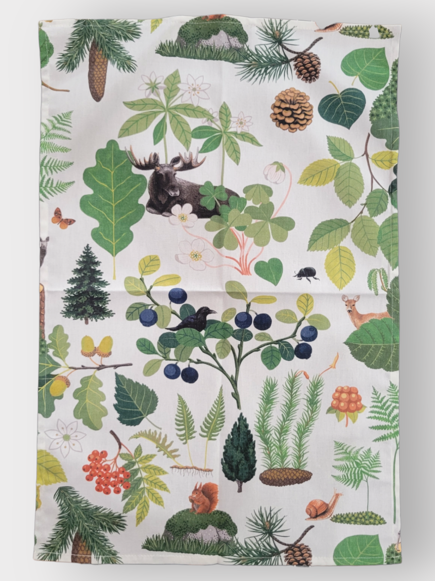 The Skogsliv Forest Life Tea Towel by Arvidssons Textil of Sweden (18" x 27") features illustrated moose, deer, birds, pine trees, branches, leaves, berries, pinecones, mushrooms, and small mammals in a forest-inspired design.