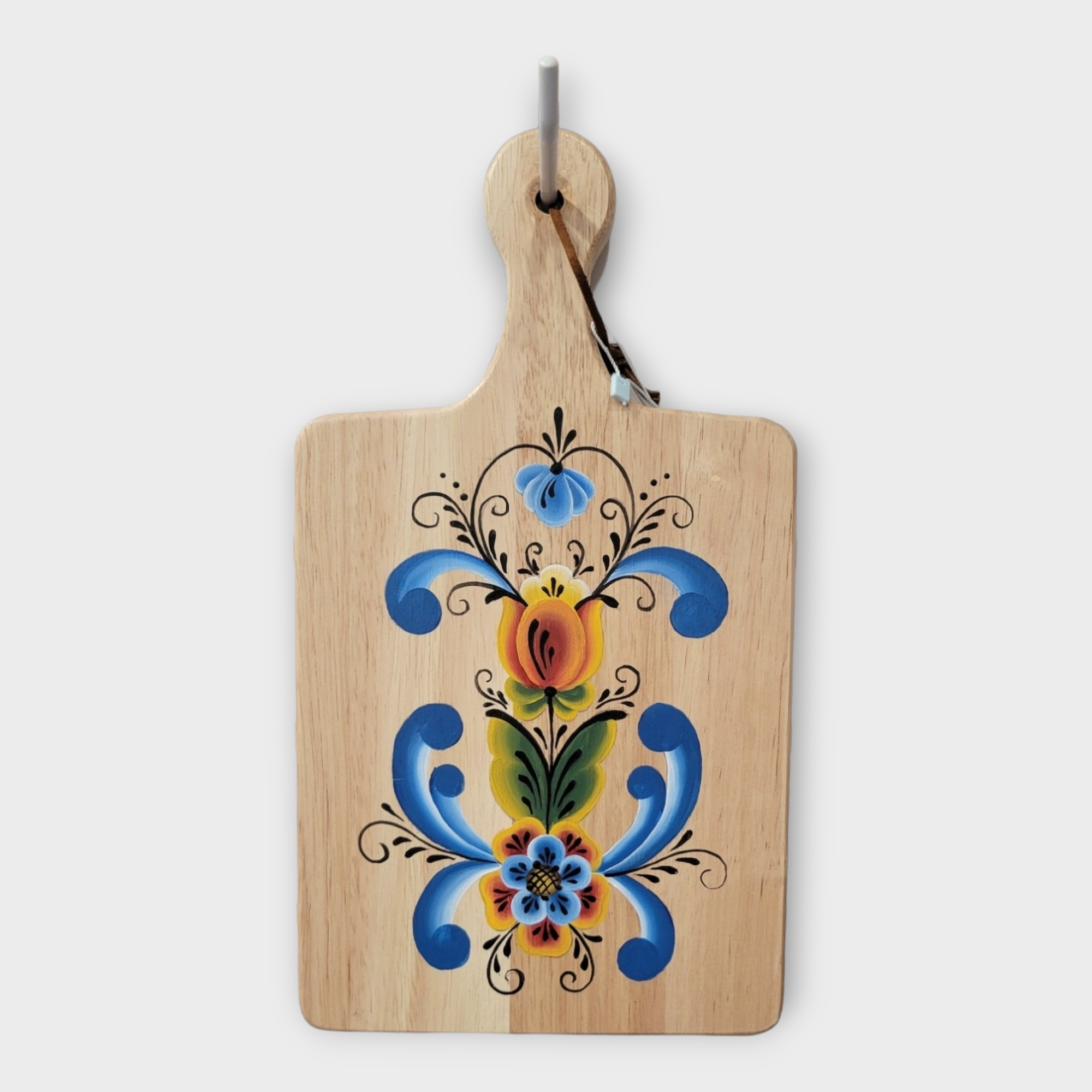 The Artwork: Swedish Folk Art Hand Painted - Kurbits Bread Board features a handle and showcases a vibrant blue, yellow, and orange floral kurbits design inspired by traditional Swedish folk art.