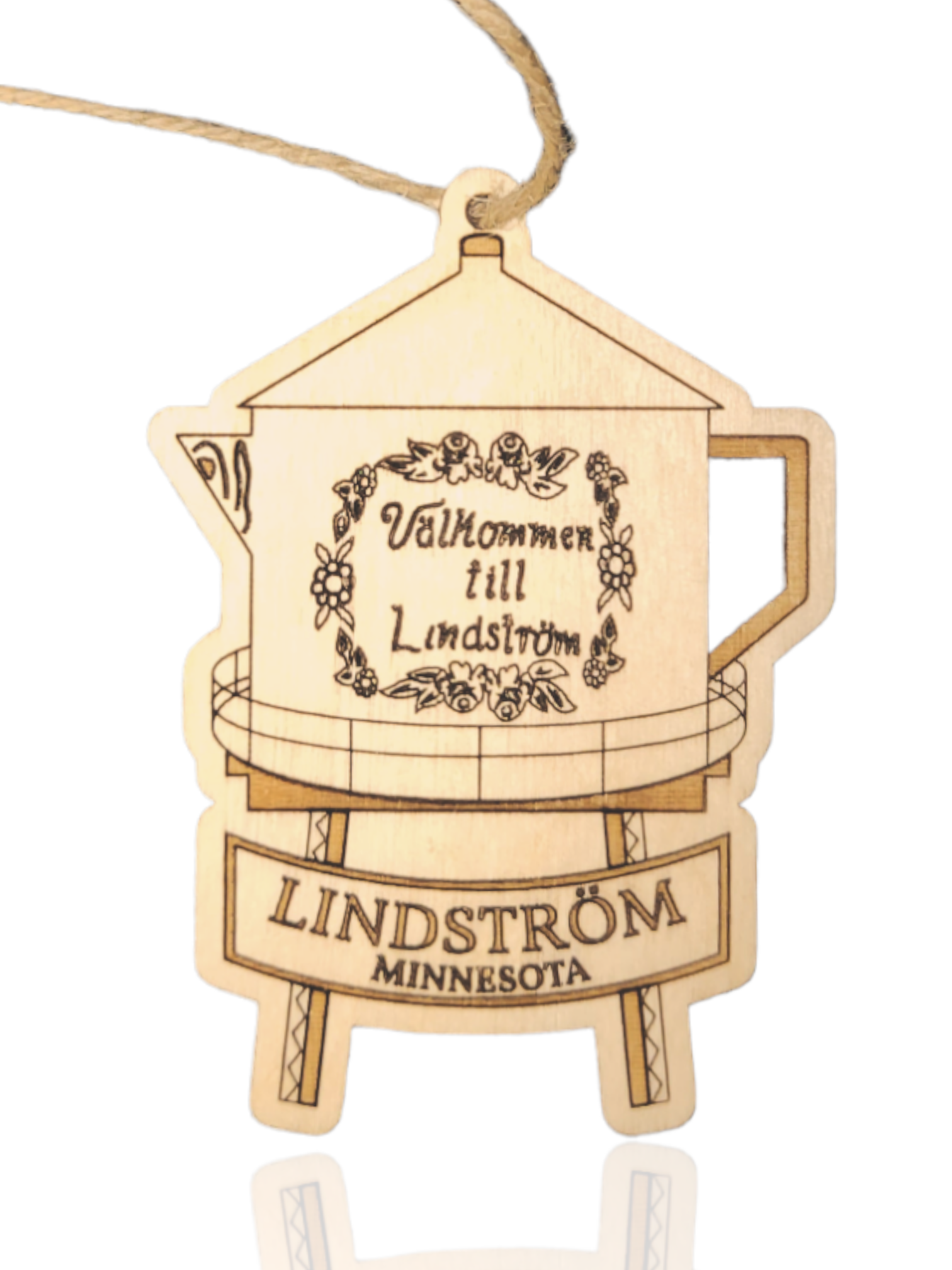 Ornament: Lindstrom Water Tower - Etched Wood, a wooden piece shaped like Lindstrom's famous coffee pot water tower, with "Välkommen till Lindström" inscribed and "Lindström Minnesota" beautifully etched on the stand below.
